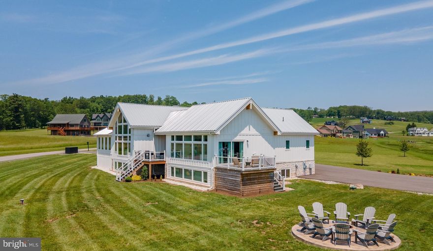 Experience elevated living in this luxury contemporary home.  Built in 2023, this was thoughtfully designed for both relaxation and entertainment.  Boasting 7 spacious bedrooms and 6 beautifully appointed bathrooms, this turnkey property comes fully furnished and ready for immediate enjoyment or continued rental success.  With an established rental history exceeding $100K annually, this home presents an outstanding investment opportunity as well as a luxurious retreat. The open concept layout showcases a gourmet kitchen with high-end finishes, seamlessly flowing into expansive living and dining areas accented by two cozy fireplaces.  Designed for year-round enjoyment, the home features a private indoor pool, a state-of-the-art home theatre and a fully equipped game room-perfect for hosting guests or creating unforgettable family memories.  Step outside to enjoy easy access to the par 3 golf course or spend some quiet time paddling your canoe or kayak at the lakefront of Deep Creek Lake.  Relax on the large deck providing comfortable living room style seating with oversized hot tub and gather around the cozy fire pit area during cooler Garrett County evenings. This private community offers multiple other amenities for fun to include a clubhouse, tennis courts , picklebalI and mini-golf.  Ideally located near popular area attractions, you will have both convenience and easy year round access for all things fun at Deep Creek!