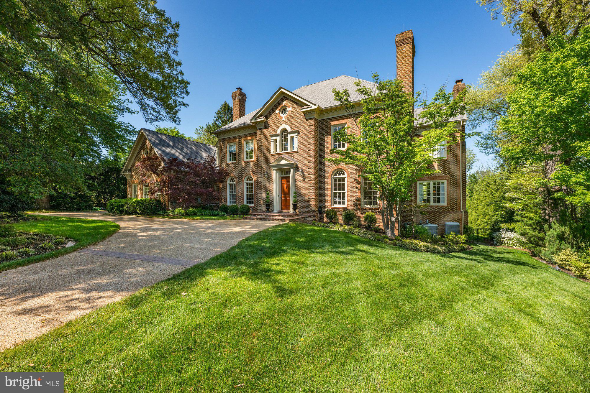 Timeless elegance nestled in the heart of prestigious enclave of Langley Farms—one of McLean’s most sought-after neighborhoods—this exquisite Georgian residence, masterfully built by renowned builder George Sagatov, offers a rare blend of classic architecture, modern luxury, and timeless sophistication. Set gracefully on a one-acre lot of mature, professionally designed landscaping, this home is an exceptional offering for the discerning buyer.
From the moment you arrive, this distinguished estate captivates with its grand approach and stately curb appeal. Upon entry, a soaring foyer, resplendent with marble tile, an elegant staircase, and intricate trimwork, establishes the standard for the impeccable finishes found throughout the home. The foyer unfolds into a magnificent great room, anchored by a commanding fireplace and framed by expansive windows that reveal sweeping views of the lush backyard and stunning swimming pool.
Natural light floods the residence, highlighting the remarkable craftsmanship—arched windows, high ceilings, and extensive millwork that elevate each room. The formal living room is anchored by a marble-surround masonry fireplace with gas logs, while the dining room features a second fireplace, built-in cabinetry, and seamless access through a remodeled butler’s pantry to the heart of the home: the gourmet kitchen.
Thoughtfully reimagined and recently renovated for today’s chef, the kitchen is a masterpiece of form and function with custom cabinetry, quartzite countertops, premium stainless steel appliances, a generous center island, and abundant natural light. French doors open to an elevated patio overlooking the private rear grounds and large shimmering pool—perfect for alfresco dining and entertaining.
The richly appointed office features bespoke wood paneling, a marble surround masonry fireplace with gas logs, built-in bookshelves, and a charming window seat, creating an inspiring space to work or reflect.
Upstairs, the luxurious primary suite is a serene retreat, offering a renovated spa-like bathroom with dual vanities, soaking tub, separate shower, water closet, skylights, and a spacious walk-in closet. Three additional en-suite bedrooms, each with walk-in closets, complete the upper level.
The walk-out lower level is a destination unto itself—designed for both entertainment and relaxation. With high ceilings and full-sized windows, this level includes a generous wet bar, gracious wine cellar, billiards room, gym, and a large recreation space with a striking stone masonry fireplace with gas logs. A private guest suite with a full bath provides ideal accommodations for visitors. Multiple access points lead to the expansive rear terrace, where the glistening pool, lush lawn, and dedicated garden area offer a resort-style experience with complete privacy.
Additional features of this exceptional residence include six elegant masonry fireplaces with gas logs that add warmth and character throughout the home, as well as a state-of-the-art solar panel system with battery backup, ensuring energy efficiency and peace of mind. The fully fenced rear yard offers multiple entertaining zones, perfect for gatherings or quiet relaxation. With approximately 6,850 square feet above grade and approximately 10,000 finished square feet across all levels, there is ample space for formal entertaining or everyday living. A circular driveway and a side-loading three-car garage provide both convenience and impressive curb appeal.
With a classic floorplan enhanced by thoughtful renovations and set on a beautifully landscaped lot, this extraordinary residence offers an unmatched combination of elegance, comfort, and modern convenience—all just minutes from the best of McLean and Washington, D.C.