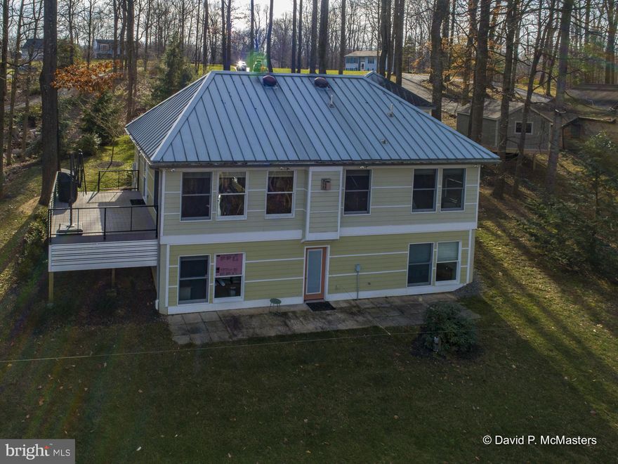 PRICE REDUCTION An architect designed and supervised every step in the building process of this modern, elegant  water front home and has occupied the home ever since.  Every detail was carefully thought out and he has maintained the property meticulously. HIGH SPEED INTERNET WORK FROM HOME Sited on 1.3 acres with towering trees and beautiful landscaping  this waterfront home  has wonderful river views overlooking the Potomac.  Kayak, canoe, swim, fish from your front  yard  The exterior of the house is cement hardi -plank  board siding.  Some of the special features are radiant heating provided through the main floor, wood floors, a commercial grade metal roof,  sandstone tiles in the two full  baths. The interior doors are commercial size and quality and there are automatic interior lights. This has to be the easiest to maintain and durable house we have ever seen; a true get away to relax and not have to fix things.  And then there is the Potomac River dominating many views from the Anderson windows. Each floor has a huge room which can  be used for many purposes.  The owner uses the large room downstairs as his office; it and the home have HIGH SPEED INTERNET.  It has lots of closet space and can be used as a third bedroom.  The Azak floored deck under the trees and looking to the river is a delight.  The seller has provided a complete description of many of the special features  that is included in the documents with the listing. Convenient location for commuters or for second home folks from the metro areal.  Community has a river access area for a boat launch, picnics etc.   The home is located about 10 minutes from  I-81,  20 minutes to Hagerstown, MD.,  25 minutes from Martinsburg, WV which has  MARC commuter train service to Washington DC and the "federal" Maryland suburbs. DC is also accessible via I-70 which is 20 minutes drive from the home. One last feature is a very low Homeowners fee of $75/year,  The roads in the subdivision are State maintained. Low taxes. Low Utilities Costs ( well insulated).High Quality Construction. Built to Last. Low maintenance.  Property provides a peaceful, quiet setting with beautiful views and Potomac River Frontage