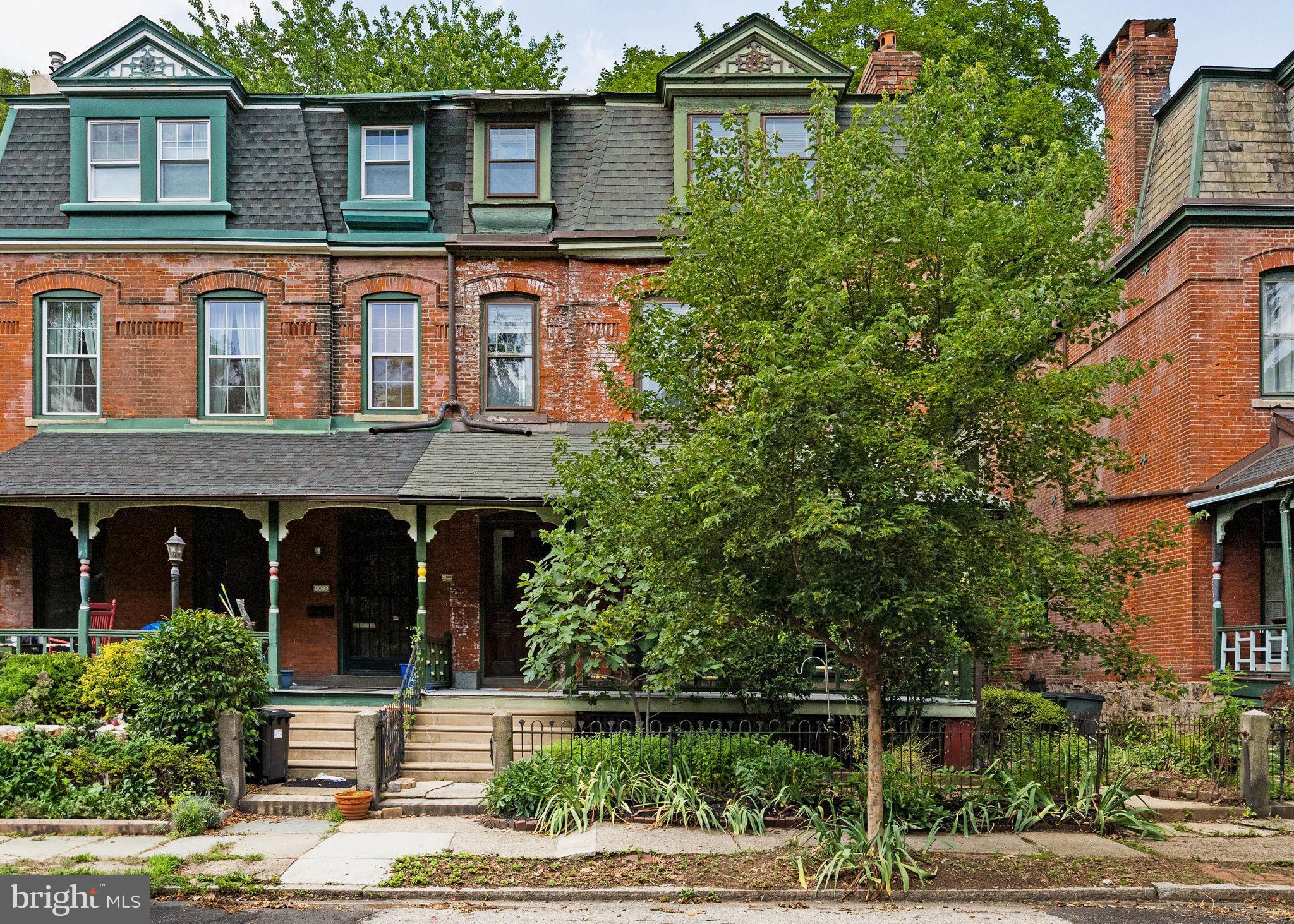 Some places just have that something — a story, a soul, a sense of belonging from a bygone era. Picture it: 1889. Grover Cleveland is president, the Exposition grounds are bustling, and your soon-to-be home is just being built, one of 14 stately brick Queen Anne Victorians lined up like a debutante parade under a canopy of mature trees. Over a century later, they’re still turning heads with their colorfully painted porches, mansard roofs, and impeccably manicured gardens.
Welcome to 4813 Trinity Place. This stately home has seen horse-drawn carriages, streetcars, Prohibition parties (probably), and countless cups of neighborly coffee sipped on its gloriously wide front porch. From the moment you step inside, you'll be transported back in time to an era of craftsmanship and elegance. This house has seen a lot of stories, and it’s ready for yours.
You’re greeted with a vintage-tiled vestibule and a foyer with a sweeping staircase that practically begs for a dramatic entrance. In the formal living room, soaring plaster ceilings and Jeffersonian windows let in all the light and grandeur you could want and a wood-burning fireplace promises cozy evenings and good conversation. Adorned in beautifully patterned vintage tile, this is the kind of detail that would cost a small fortune to recreate today and would make any modern builder weep with envy.
The formal dining room is ready for all the Friendsgivings, holiday feasts, and impromptu game nights you can imagine. Then slip through the butler’s pantry like the host you were born to be. The kitchen is spacious and features butcher block countertops, a deep farmhouse sink with antiqued brass fixtures, original shelving, and the pièce de resistance: a vintage-inspired six-burner, 39-inch, cast iron AGA range that has you dreaming of simmering stews and fresh-baked bread. Oh, yes, it’s as glorious as it sounds. There’s also a sunny breakfast room with beadboard, exposed brick, and a half bath. Out back? A large private deck perfect for summer soirées, fire pits, and dinner parties under the stars.
Head upstairs to the second floor for a cozy den with built-in bookshelves and a fireplace with delicate decorative tile, perfect for evening reads, movie nights, or wine sipping. And let’s not forget the sleeping porch accessed through the window, a wonderfully eccentric touch for daydreaming, napping, or reading while a breeze rustles the trees. Rounding out the floor are two bedrooms, including one with a stunning marble en-suite bath that would make any boutique hotel jealous.
On the third floor is your Primary Suite, a true sanctuary with a custom walk-in closet and a spectacular spa-like en-suite bathroom. Picture deep emerald subway tile, antique brass fixtures, a glass-enclosed shower, and a clawfoot tub that’s practically screaming for bubble baths and champagne. A second room, perfect for a nursery or home office, completes the floor.
And while the house itself is an architectural love letter, the neighborhood is the perfect supporting cast. Stroll through Cedar and Clark Parks, hop the streetcar on Baltimore Avenue, and immerse yourself in an eclectic scene of historic homes and indie shops. Grab your groceries at Mariposa Food Co-op, sip a latte at Gold Standard, devour a vegan donut at Dottie’s, or get your margarita fix at Loco Pez. And brunch at Booker’s? Just trust us on the shrimp and grits.
4813 Trinity Street isn’t just a house. It’s a living, breathing piece of Philadelphia history, ready to tell its stories, and even better, ready to be part of yours.