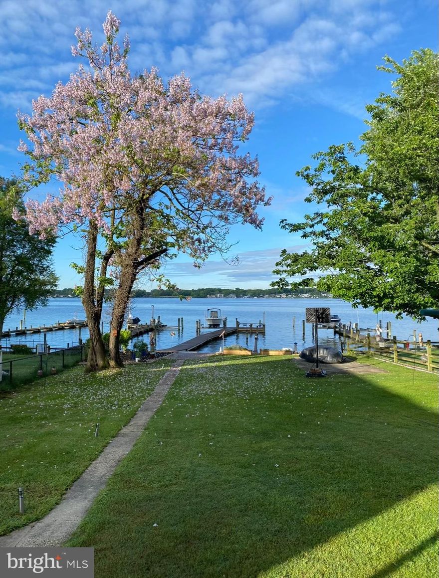 NEW PRICE REDUCTION!!
Great news...NO FLOOD INSURANCE REQUIRED, Save thousands ($$) annually.
Waterfront Living at Its Finest. Sellers say "SELL"! 

Welcome to a slice of serenity at the end of a peaceful, tree-lined street—where timeless charm meets breathtaking waterfront beauty. This 4-bedroom bungalow isn’t just a home—it’s a lifestyle, offering the perfect blend of comfort, elegance, & the soothing rhythm of waterfront living.

Step outside and prepare to be wowed by your personal waterfront retreat. The pride and quality of construction found here is what every waterfront homeowner dreams of—& it’s all right here.
At the River’s Edge, you’ll find an expansive new, 1,000 sq ft concrete patio—a true showstopper & entertainer’s dream. Designed w/ gatherings in mind, it features generous space for outdoor seating and a cozy fire pit setup, all surrounded by low-maintenance finishes. With a smooth flow from the house through the yard to this spectacular outdoor living area, it's the perfect setting for relaxing under the stars or hosting celebrations w/ friends and family.

Beyond the patio, every inch of the waterfront has been carefully considered and beautifully curated. A wide, brand-new 100-foot pier stretches elegantly into the river, leading to a private, spacious wooden deck with custom built-in benches at the end of the pier—perfect for fishing, lounging, or simply soaking in the incredible water views. It’s the most magical place to start and end each day—& the ultimate spot to create memories that last a lifetime.

If you’ve been waiting to truly start living, this backyard oasis delivers. It comes fully equipped w/ a new 12,000 lb. boat lift, new bulkhead & retaining wall, complimented by a tranquil koi pond that adds peaceful, meditative energy between the home & the water. Strategically placed seating along the pier & bulkhead invites you to pause, breathe, & take it all in. 

From sunrise to sunset, the sweeping river views create a constantly evolving masterpiece just outside your door. Whether you're enjoying backyard barbecues or peaceful waterfront mornings, 1004 Thompson offers a rare & remarkable opportunity to enjoy the very best of waterfront living—w/ the peace of mind that every upgrade has been completed for you to simply enjoy.

Inside, the heart of the home is just as thoughtfully designed. The living room opens onto a covered back porch, perfectly framing the panoramic water views. Whether you're sipping morning coffee or unwinding in the evening, every moment here feels special. The main level includes two bedrooms, one with a sliding glass door overlooking the water.

Warm hardwood floors flow throughout, adding richness and charm. The kitchen offers generous counter space and is equipped with a one-year-young refrigerator, two-year-young dishwasher, wall oven, cooktop, and ceiling fan—blending classic craftsmanship with modern convenience.

The sunroom bump-out provides additional flexible living space and includes a main-level laundry area with a two-year-young dryer and oversized washer—ready for whatever adventures waterfront life brings your way.

Upstairs, you’ll find two more generously sized rooms, one with water views, and a convenient half bath. The layout is flexible and inviting, ideal for guests, home offices, or creative spaces to grow with your next chapter.

And if that weren’t enough, the home also features a full lower level with a private entrance, spanning the entire footprint of the home and adding approximately 900 sq ft of additional space. Whether you need ample storage or are dreaming of a gym, workshop, studio, or guest suite, this level offers a blank canvas to bring your vision to life. Off-street parking and a brand-new, high-quality shed add even more functionality, giving your gear a fresh new home of its own.

Let this home spring your summer forward!!