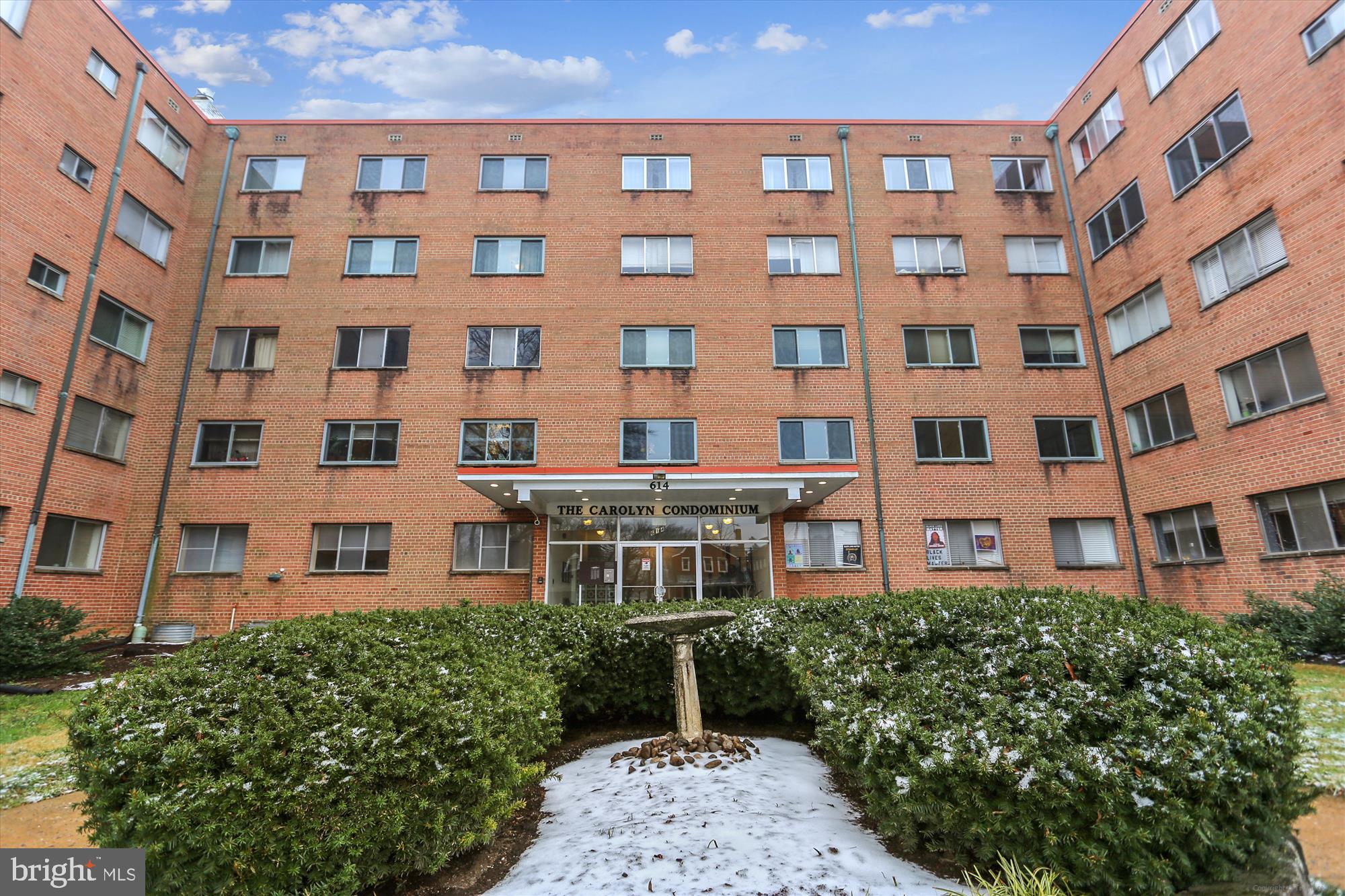 Experience sophisticated living in this top-floor corner unit featuring 2 bedrooms, 1 bath, and 1,010 sq. ft. of space. The residence is accentuated by a private balcony offering canopy views. It boasts new flooring, convenient assigned parking, an elevator, and common storage facilities. Additionally, this midrise building includes on-site laundry facilities. Ideally situated, it provides easy access to downtown Silver Spring and the tranquil Sligo Creek, merging comfort with urban accessibility.