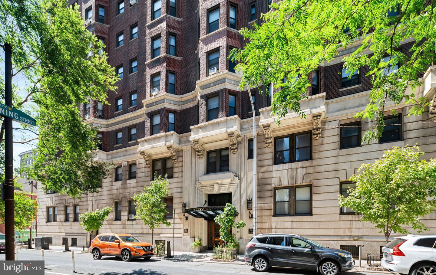 This is a Northwest corner unit at the Lenox Condominiums with large scale rooms, high ceilings and 11 windows that offer great light and skyline views. It has been well maintained and has recent upgrades including new flooring, kitchen countertops and bathroom vanity. The kitchen has a door to the fire escape and it provides great air flow. The spacious living room can be used as a combination living and dining room. The equally large eat-in kitchen has an abundance of storage space with plenty of cabinets and a pantry closet. The bedroom is 16’ x 19’ and has a bay window at one end and a ceiling fan. The extra space in the bedroom can be used as a home office or an extra seating area. The bedroom has closet space and there are two large walk-in closets in the hallwa, one could be used as a home office. The bathroom has been upgraded and includes a linen closet. The association now allows individual owners to install mini-split air conditioning and washer/dryers with prior approval, and many owners have installed them. The Lenox Condominium was designed by famed New York architects Clinton and Russell. It was built in 1920 and renovated into condominiums in 2004-5. The units have large scale rooms, high ceilings, lots of windows and many units have their original architectural elements. It is a Doorman building and is centrally located at the southern end of Mid-town Village in the Washington Square West Neighborhood. It is 2 blocks from the great shops, restaurants, theatres and nightlife of Midtown Village, Walnut Street, and the Avenue of the Arts. It is also just a few blocks from Thomas Jefferson and Pennsylvania Hospitals. There are many public transportation options within a few blocks of the Lenox. The condo fees include a 24/7 door staff, heat, hot water, and high-speed internet. The owners pay their own electric and Cable TV, and the building offers additional storage for a small fee. There are many parking, gym, and day care options within 2-3 blocks. It is a pet friendly building and the tree lined historic neighborhood is a beautiful place to walk dogs.