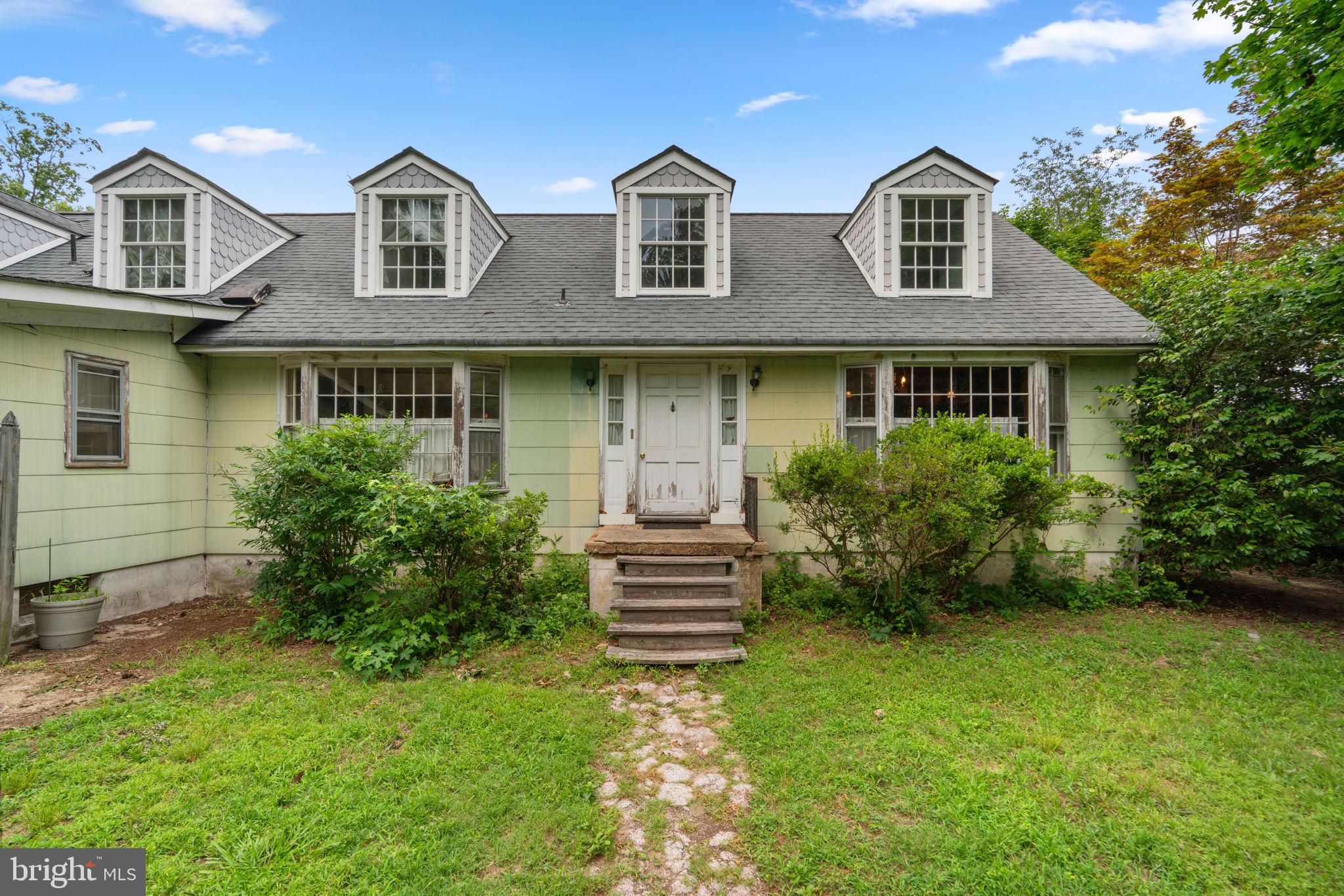 Discover the rare opportunity to own a charming waterfront Colonial in the serene and private enclave of Green Gables. With 4,684 square feet, 4 bedrooms, and 3 full baths, this charming coastal home is beautifully sited along the peaceful waters of Wharf Creek as it winds toward the Bodkin and ultimately the Chesapeake Bay. Brimming with character and possibility, this property offers boundless potential for transformation with the right vision and investment.
The main level welcomes you with a bright and inviting foyer, leading to a spacious sunroom with shoreline views. Find an adjacent cozy sitting room with hardwood floors and a brick fireplace, flanked with custom built-ins for warmth and charm. Right off the entry is the efficient eat-in kitchen featuring an island, peninsula, and pantry, and it flows effortlessly into the dining room, which is enhanced by hardwood floors, built-in cabinetry, and opens into the sunroom. Continuing on the main level, find a large family room with built-ins, 8 oversized windows, and coffered ceilings. This space opens into a living room with built-ins, coffered ceilings, a full bathroom, and access to a laundry room with built-ins and a mudroom with exterior access. Completing the main level is a dedicated library or study featuring panoramic floor-to-ceiling built-in bookshelves.
Upstairs, four generously sized bedrooms and two full baths include a waterfront primary suite that will take your breath away with panoramic views, three closets (one walk-in), and an attached full bath. Two of the secondary bedrooms also offer walk-in closets. The unfinished lower level provides ample storage space and endless possibilities for future customization. Lush and private, the backyard is surrounded by mature trees and features a convenient storage shed and steps leading down to the water’s edge. Additional features include a unique natural spring that serves as the home’s primary water source, a private circular driveway, and no HOA restrictions. Located in the desirable Green Gables community, enjoy private neighborhood access to Downs Park, scenic trails, a dog beach, a kayak launch, and a fishing pier offering a variety of watersport activities. This home is being sold as is, presenting a rare opportunity in a highly sought-after location.
