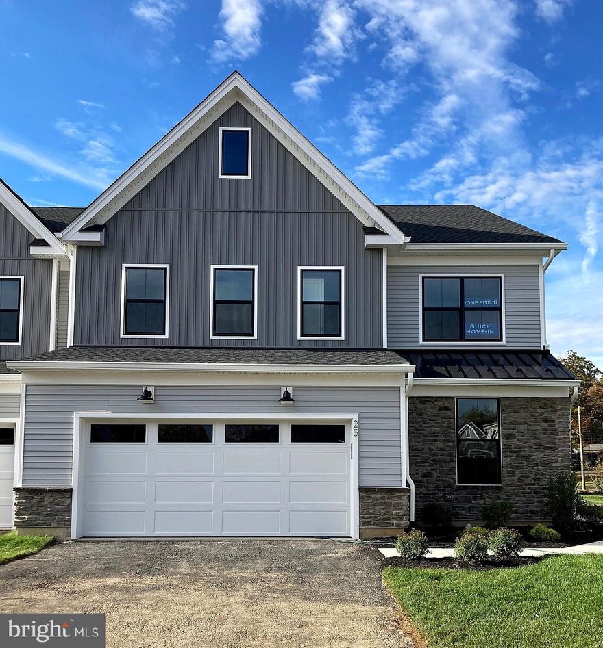 Move-in ready end-unit home featuring a desirable first-floor primary suite and an open layout designed for modern living. The welcoming side entry leads into a dramatic two-story great room showcasing a stunning floor-to-ceiling stone fireplace, complemented by abundant natural light from additional windows unique to this end location and an open connection to the bright dining area and covered outdoor living space—perfect for relaxing or entertaining. The kitchen offers quartz countertops, a stylish tile backsplash, a large center island with seating, KitchenAid stainless-steel appliances, and ample cabinetry including a generous walk-in pantry. Engineered hardwood flooring extends through the main living areas, complemented by extensive recessed lighting.

The first-floor primary suite includes a spacious walk-in closet and a spa-inspired bath with quartz surfaces, frameless glass shower enclosure, and designer tile upgrades. Upstairs, a versatile loft provides additional living space alongside secondary bedrooms with large closets and a shared hall bath. Additional highlights include built-in cabinetry in the laundry room with quartz countertop, a convenient powder room, everyday entry, and abundant unfinished storage. This home is built on a slab foundation with no basement for efficient single-level convenience.