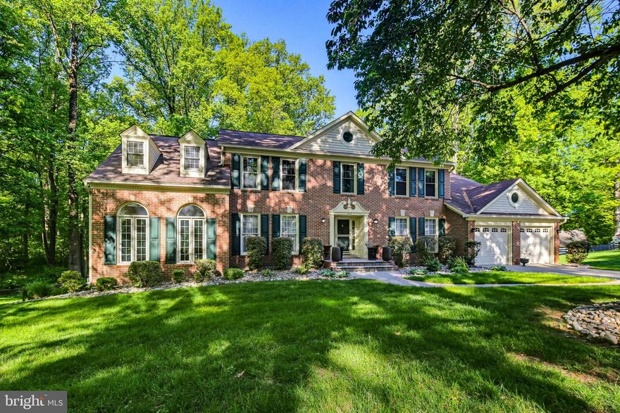 Welcome to 8368 Sand Cherry Lane in the highly sought after Cherrytree Farm community—where timeless elegance meets exceptional living! This stately brick front home, the largest model offered in the neighborhood, is perfectly situated on a wooded lot with stunning outdoor and indoor living spaces designed for both relaxation and entertaining. Step inside to a grand two-story foyer adorned with an impressive chandelier and the formal living and dining room on either side. Both rooms feature classic chair rail and crown molding. The home boasts a rare and desirable upgrade with the breathtaking two-story sunroom with a loft. The bright and airy sunroom offers vaulted ceilings, large casement windows, and panoramic views of the surrounding landscape. The thoughtfully expanded and remodeled kitchen (2012) is a chef’s dream, featuring warm medium tone wood cabinetry, granite countertops, ceramic tile flooring, and a striking center island with breakfast bar seating at the end. Additional highlights include a coffee bar with second sink, stainless steel appliances (gas cooktop, double wall ovens, refrigerator, dishwasher, built-in microwave) and stylish pendant and recessed lighting. The kitchen flows seamlessly into the breakfast room with a bay window and the dramatic two-story family room. The family room showcases skylights, hardwood floors and a cozy wood-burning fireplace. A private study with French doors, custom built-in shelves and cabinetry along with a convenient powder room completes the main level. Upstairs, you’ll find four spacious bedrooms and three full baths, including a luxurious primary suite featuring a sitting room, expansive walk-in closet and spa-like bath with Jacuzzi jetted tub, two sink vanity with makeup counter, tiled shower with bench and private toilet room. Bedroom 2 offers its own ensuite bath, while bedrooms 3 and 4 share a well-appointed Jack-and-Jill bathroom with two sinks and a separate shower/toilet area making it easy to share the space. The fully finished walk-out lower level is an entertainer’s dream—highlighted by a dedicated theater room with a theater riser for optimal viewing, built-in speakers and dim ambient lighting. There's a temperature-controlled wine cellar with custom wood racks, a recreation room with wood-burning fireplace and a full bathroom. Two additional storage rooms provide ample storage space for seasonal items. The outdoor space is equally impressive with a composite deck off the kitchen and family room and a beautifully designed patio with a pergola draped in wisteria. Really enjoy the serene setting of the wooded backdrop this Spring and Summer! Improvements & updates include: 2023 - Family Room & Office Windows, 2022 - Sunroom Windows, 2021 - Upper Level Window, 2021 - HVAC for Sunroom, 2020 - Pergola, 2019 - Patio & Retaining Wall, 2019 - Front Walkway, 2016 - Hardwoods In Sitting Room & Primary Walk-In Closet, 2016 - Upper Level Carpets, 2015 - HVAC for Main Level, 2015 - HVAC for Upper Level, 2014 - Hardwoods In Family Room & Study, 2013 - Water Heater. Howard County Public School System! Minutes from Maple Lawn’s shopping, dining and entertainment! Ideal for commuters with easy access to I-95, Route 29 and Route 32, offering convenient travel to Baltimore and Washington, D.C. One year home warranty included for the Buyers! This exceptional property truly has it all—schedule your showing today!