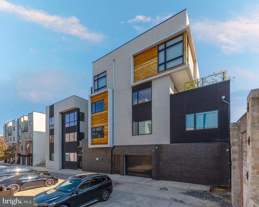 818 N 4th St #LL is a one-of-a-kind modern, luxury condo in the heart of Northern Liberties. Custom built with sleek architectural details and minimalist finishes, this flat unit offers 3 beds, 2.5 baths, garage parking, and a private terrace. The main living space is open and airy, with concrete floors and a wall of windows providing tons of natural light. The stunning kitchen is fitted with black cabinetry, lots of hidden storage, and high-end appliances. The home's primary suite, also naturally lit by a wall of windows, features a soaking tub that's filled from the ceiling in the bedroom, a custom closet, and a true spa-like bathroom with wood finishes for a warm and calming feel. At the center of the unit is an expansive private terrace that acts as a light well. This space is an entertainer's paradise that can be opened to the living spaces for easy indoor/outdoor gatherings. In addition to everything inside, this fantastic Northern liberties location earns a Walk Score of 97! Hotspot Cafe La Maude is right next door, plus there's easy access to booming 2nd St, idyllic parks, I-95, and South Jersey.