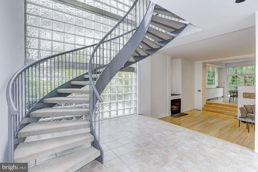 This groundbreaking contemporary was featured on the cover of the Home Section of the Washington Post. Open spaces are filled with light and drama. High ceilings, glass block walls, skylights and a center hall spiral staircase will take your breath away! Enjoy wooded views,walk to shops, restaurants, hike,bike, kayak along C&O Canal. Whitman Schools. Minutes to DC & VA.