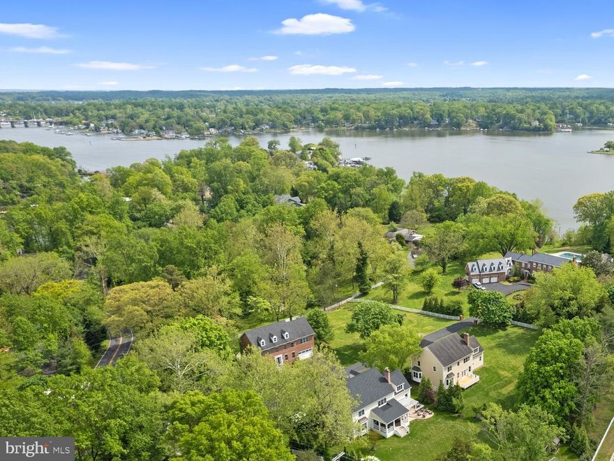 Stately Colonial tucked away in a small enclave of homes with community water access to the South River.  This 5 bedroom, 5.5 bath home has been recently refreshed with new carpet, refinished hardwood floors and neutral paint throughout.  The tall ceilings and classic design elements provide an elegant and airy atmosphere in every room.  From the exterior molding details to the beautifully crafted woodwork on the interior of the home it is evident that no details were compromised in presenting a home of distinction. Upon entering the residence, the formal living and dining rooms flank the open foyer which flows through to the Family room and Kitchen. The gourmet Kitchen has plentiful seating around the large island, conveniently located wet bar with beverage fridge and lots of cabinet and counter space.  The bay window overlooking the rear deck and backyard is a perfect location for enjoying a morning coffee.  The adjacent Family Room with impressive stone fireplace and access to the rear deck entices for an evening of relaxation; inside or out. 4 bedrooms adorn the upper level, all with ensuite bathrooms; the ultimate in privacy for a large family or guests.  The expansive Primary suite can easily accommodate a king size bed and sitting area and the luxurious spa-like bath matches the grandeur with jacuzzi tub, 2 vanities with ample counterspace, walk-in shower, water closet, and large closet space. An unfinished bonus attic space offers additional square footage for the future. On the lower level a vast recreation room, bedroom, bonus room/bedroom and full bath can offer a variety of uses.  Completing this splendid property is a 2 car garage and spacious, level backyard. Located on a quiet street just steps from the water's edge and minutes away from everything Annapolis has to offer.  Welcome Home!