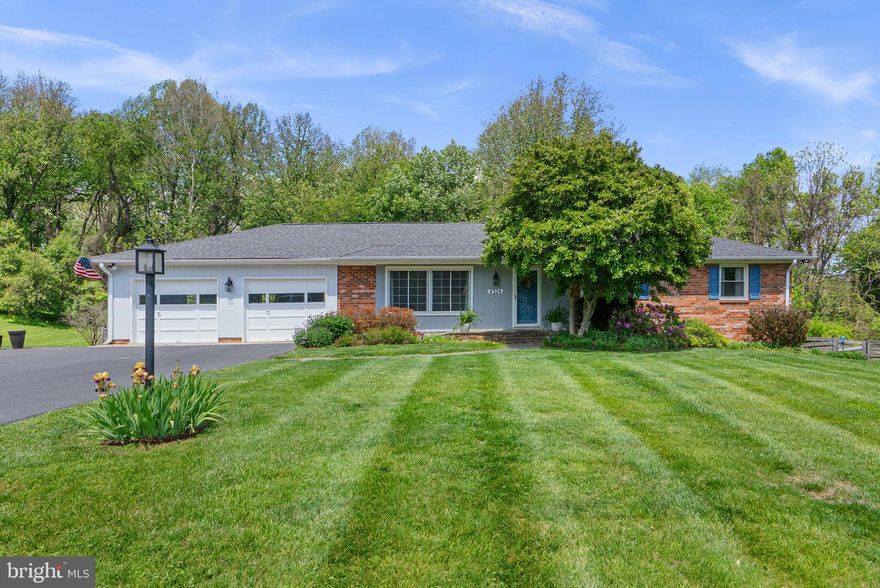 Welcome to your dream home! Nestled on a quiet street backing to scenic parkland, this exceptional, turn-key residence offers breathtaking views and over 1,000 square feet of additional living space thanks to a stunning two-story addition. Prepare to be enthralled by this beautifully reimagined rambler blending timeless craftsmanship with modern updates designed for today’s lifestyle. Step inside to a bright, formal living room featuring gleaming hardwood floors and an abundance of natural light. The updated gourmet kitchen is a true centerpiece, complete with granite countertops, stainless steel appliances, a custom backsplash, hardwood flooring, and a spacious walk-in pantry. The kitchen flows effortlessly into the expansive sunroom addition, showcasing cathedral ceilings, walls of windows, and sliding glass doors that open to a private deck—creating the perfect space for entertaining or relaxing. The main-level owner’s suite offers hardwood floors and a fully renovated en-suite bath with a double vanity, designer tile flooring, and a walk-in shower. Two additional bedrooms and an updated full hall bath complete this level.
Downstairs, enjoy a fully finished recreation room featuring a cozy wood-burning, brick-surround fireplace, a convenient kitchenette, and sliding glass doors leading to your private backyard oasis. The outdoor space includes a covered paver patio and serene nature views that truly impress. The lower-level addition adds incredible flexibility with a spacious fourth bedroom, sitting area, oversized walk-in closet, a third full bath, laundry room, and ample storage. Additional highlights include an oversized two-car attached garage and a prime location just steps from community walking trails and multiple renovated playgrounds. Meticulously maintained by the current owners with every detail thoughtfully and tastefully addressed, this home shows like a model and is truly move-in ready. Don’t miss this rare opportunity to own the perfect home in an unbeatable setting—schedule your private showing today!