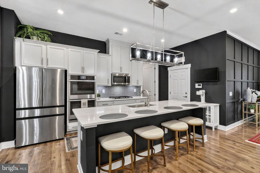 Welcome to a home that truly has it all, style, comfort, and thoughtful upgrades throughout! The beautifully maintained exterior features an in-ground sprinkler system (front and back), a brand-new garage door, and a private backyard backing to a serene grassy hill. The garage offers upgraded flooring (10-year guarantee) and ample storage.

Inside, enjoy wide-plank luxury vinyl plank (LVP) flooring, soaring 10-foot ceilings, and a stunning brick fireplace. The gourmet kitchen features quartz countertops, stainless steel appliances, double oven, gas cooktop, and an oversized island. A bright sunroom adds flexible living space, while the first level primary suite offers a spa-inspired bath, sunken tub, custom closet, and private retreat. Laundry includes a built-in coffee bar for added convenience.

Upstairs offers additional living space, two spacious bedrooms with a shared bath, ceiling fans, and a dedicated storage room with built-in shelving. Additional upgrades include UV-protected windows, full house clean water system, whole house humidifier, and custom closets throughout.

Located in The Retreat at Poland Hill, a sought-after 55+ community in Chantilly, with easy access to shopping, dining, and major commuter routes. Amenities include a clubhouse, pool, fitness center, walking trails, and low-maintenance living with HOA services.

This is more than a home, it is a lifestyle. Schedule your showing today!

Some images may reflect virtual staging or digital editing, including removal of personal property, to help showcase the home.