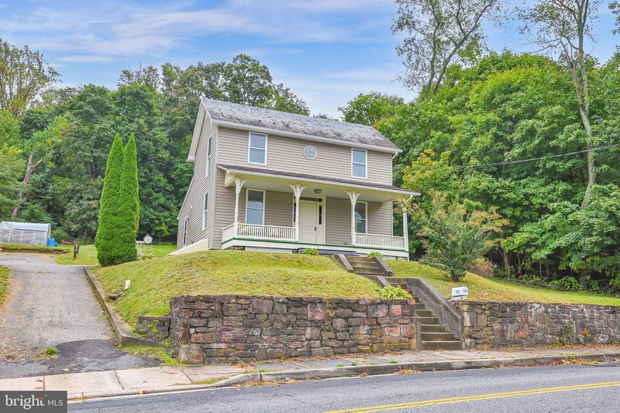 Charming and Bright Colonial in the town of Whiteford with many updates and generous size rooms. The main level has the  primary bedroom, laundry and a full bath along with an eat it Country Kitchen and spacious living room. You will find hardwood floors in the kitchen and living room and new carpet in all of the bedrooms plus the interior of the home has been freshly painted. Enjoy the evening sunsets on the full covered recently painted front porch with new flooring. On the upper level of the home are two ample sized bedrooms along with another full bath. The home has an unfinished gravel-floored walking height basement that is accessible from the outside. Delta Peach Bottom Area Slate roof on the main part of the home and a new shingle roof on the rear addition and dormer. The interior of the home was totally renovated in 2005 with new bathrooms, kitchen, drywall, HVAC, electric and plumbing, as well as new vinyl siding on the exterior. Replacement windows throughout and comfortable central air. New electric hot water heater 9/24.  A new well was also drilled in 2005 with a yield of 11 gpm and 225' deep. The property has public sewer. (Deferred water/sewer charges of $232.00 annually until July 2033). Move in ready, low taxes and a must see at this price!