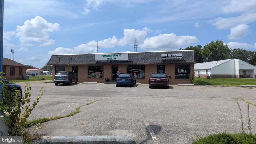 ±4,396 sqft three-unit shopping center available for sale in Cambridge, MD. Two of the three units are leased to long-term tenants, providing stabilized income with upside through lease-up of the remaining space. Ideal for an owner-user looking to occupy a unit while offsetting expenses, or for an investor seeking consistent cash flow with value-add potential. Building is centrally located approximately 500’ from Rt50 and benefits from nearby apartment communities and proximity to Cambridge’s primary retail corridor. The brick/block building features a newer roof installed around 2016. The occupied units are in good condition, while the vacant unit is currently gutted, allowing flexibility for a buyer’s intended use or tenant. The site includes additional land area that may offer redevelopment or expansion potential. A strong opportunity to acquire a small shopping center with income, flexibility, and long-term upside.