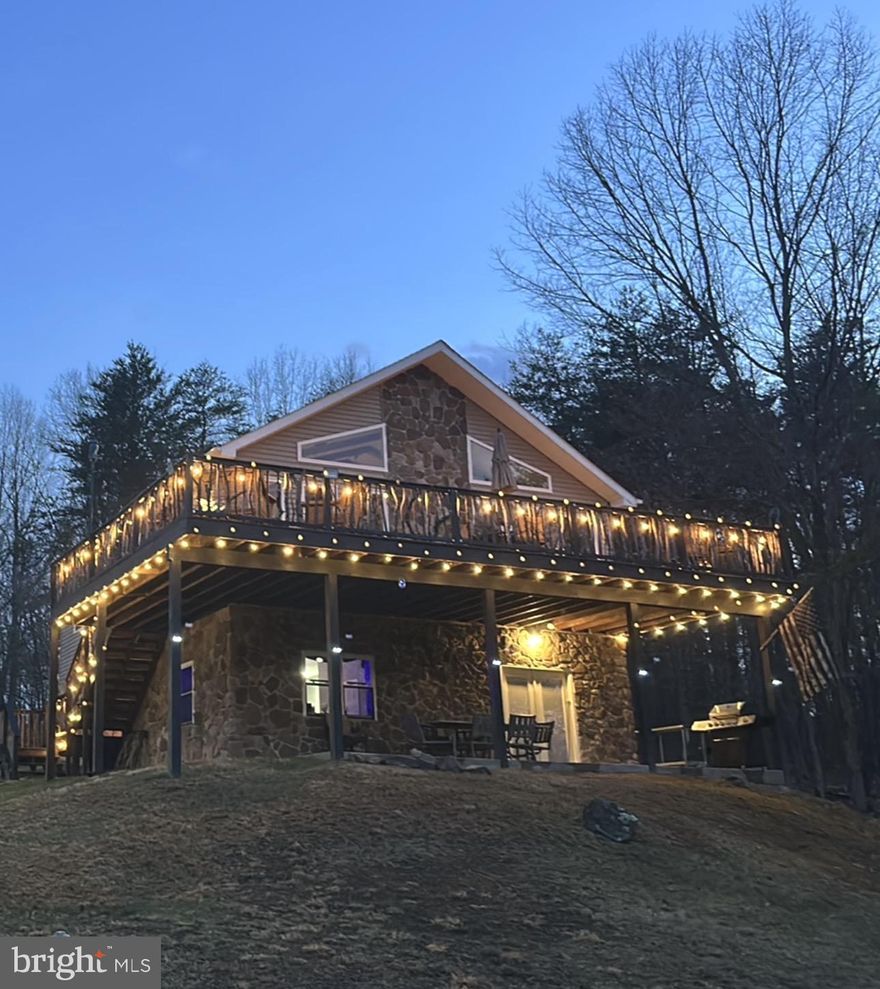 This mountain home is within the community of Ashton Woods. Pride of ownership will be quite obvious when you come to inspect this property.  The owners have made considerable improvements to the property in the short time they have owned it.  Recently, tall trees have been removed to enhance mountain views from the home and the oversized deck.  You’ll feel the openness of the main level living area with vaulted and beamed ceilings, skylights and oversized windows.  The family room on the lower level is quite spacious also, perfect for entertaining or for your own recreation.  An outside patio underneath the deck is protected from weather overhead. Included is an oversized, detached garage with finished interior.  There is a maintained path down to the stream and a hunting blind for the avid hunter.  .  This gated, mountain community is comprised of over 10,000 acres with primarily 20+ acre lots throughout.  The drive from Northern Virginia is within 2 to 2.5 hours.  Drive to Nathaniel Mountain Wildlife Management Area (10,000 acres of public Hiking and Hunting) and multiple public access points on the South Branch of the Potomac River in 15 minutes. You are 20 minutes from Moorefield (Restauants, WalMart!, Golf Course).  45 minutes to Ski Resorts., about an hour to Winchester. VA. All contents will convey with the sale. The furnishings are of nice quality.