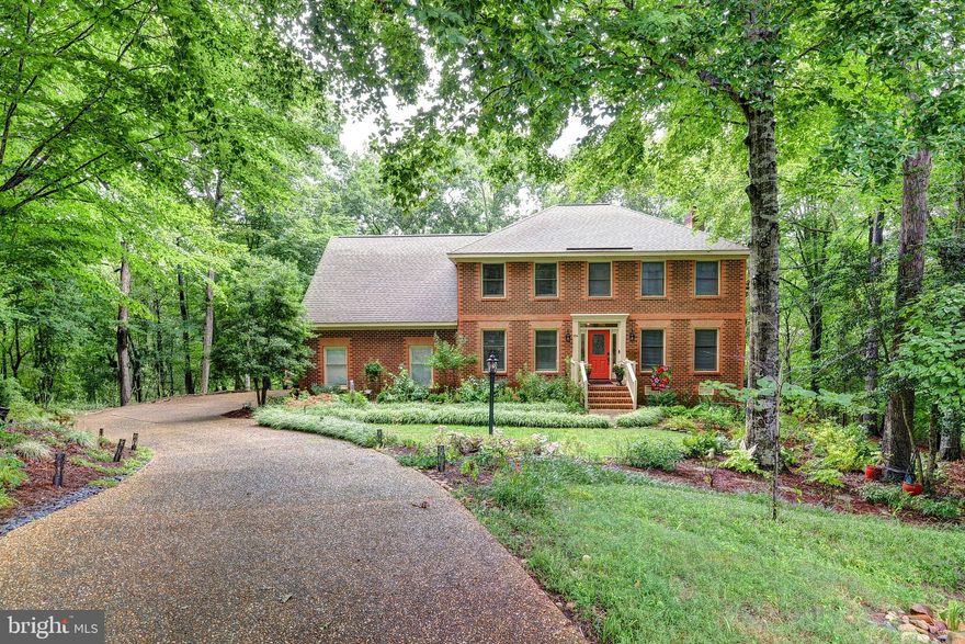 Beautiful waterfront all-brick Colonial on 55-acre Laurel Lake. Located in Williamsburg’s Banbury Cross subdivision, this custom built home rests on 1.32 private acres, surrounded by lake views, hardwoods, Mountain Laurel with uniquely and thoughtfully designed landscape maintained by a true Master Gardener. With 4 bedrooms, 3 full baths, living room, dining room, sunroom, all of which are versatile and can be set up for almost any lifestyle. The family room with wood burning fireplace opens to the eat-in kitchen. The oversized attached 2 car garage provides plenty of storage. End of cul-de-sac, enjoy private, convenient location only minutes to Sentara Hospital, shopping, Colonial Williamsburg, New Town, military bases, local attractions, dining & I-64! Escape to peace & tranquility with this wonderful retreat. Banbury Cross features a large community green space with path, large private lots.