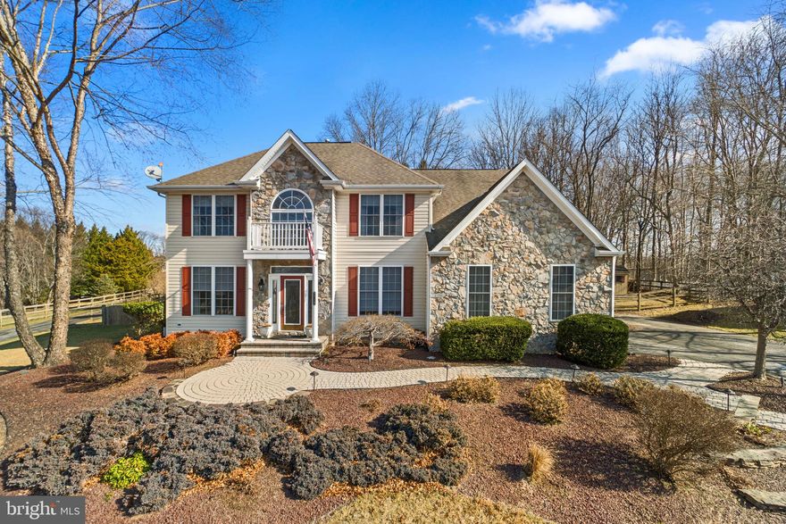 Nestled on nearly a full acre in highly sought-after Friendship Farms, this stunning colonial offers exquisite curb appeal with lush landscaping, expertly manicured gardens, and a striking combination of stone and vinyl siding. A charming Juliet balcony above the columned entryway adds to its timeless elegance while meandering walkways, vibrant window shutters, and a spacious driveway with ample parking complete the picturesque exterior.

Inside, a grand two-story foyer with gleaming hardwood floors sets the stage for a beautifully appointed traditional layout. French doors open to a sophisticated study, while a stylish powder room with hardwood flooring is conveniently located nearby. To the left, the formal living room seamlessly flows into the dining room featuring plush carpeting, elegant columns, and refined wainscoting. The bright and inviting eat-in kitchen, updated in 2020, showcases granite countertops, a chic backsplash, a center island with pendant lighting, and stainless steel appliances, including a 2024 dishwasher, a 2021 refrigerator, a 2023 oven, and a 2021 cooktop. Hardwood floors extend into the breakfast area, which offers direct outdoor access and opens to the spacious family room with coffered ceilings and a dramatic floor-to-ceiling stone gas fireplace.

Upstairs, a convenient laundry room with recently installed washer and dryer (2024) is surrounded by four generously sized bedrooms. Hardwood floors extend from the upper walkway into the luxurious primary suite boasting a cathedral ceiling, a walk-in closet, and a spa-like ensuite with a frameless glass-enclosed shower, a corner jetted soaking tub, and a dual vanity. The rest of the bedrooms are carpeted, with two featuring walk-in closets. A well-appointed hall bath with dual sinks completes this level. Designed for entertaining, the fully finished lower level is a true showstopper. Luxury vinyl tile flooring extends through the expansive recreation room, which includes a kitchenette for added convenience. A versatile bonus room—perfect as a fifth bedroom—features walk-up exterior access and an attached full bath with dual entry to the rec room. Additional storage space ensures everything has its place.

Outside, the backyard is a private oasis with an expansive paver patio, a pergola-covered hot tub, and a beautifully landscaped, fenced yard adorned with mature trees for shade and seclusion—all set against breathtaking pastoral views. With a recently installed HVAC system (2024), refreshed hardwood and carpeted floors, and an upgraded water filtration system, this exceptional home blends timeless charm with modern comfort in an unbeatable location.