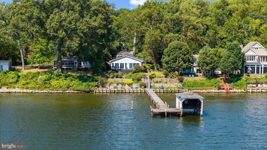 Charming contemporary cottage located on the shores of Little Round Bay looking out across to St. Helena Island, the Severn River and beyond. Unobstructed panoramic views allow for year round enjoyment of all the ever changing scenery and wildlife activity on the water. This elevated vista with 0.45 acres of land and approximately 75+ ft of waterfrontage along side the private deep water (8ft MLW) pier with coveted boathouse, this property has something for everyone and the potential is endless. Renovate the existing 2500+ sqft, 4 bedroom 3 bath home or build your dream home on this spectacular site. The expansive view captures your attention upon entering the property and the open floor plan integrating the dining room with the living room is sure to be where everyone will congregate to enjoy the view. Open the sliding glass doors to experience the cool breezes; perfect for indoor/outdoor living. Step right outside the sliding doors to the spacious deck, patio and path to the water's edge and private pier providing quick access out to the Severn River to downtown Annapolis, the Annapolis Harbor, Chesapeake Bay and beyond. Conveniently located off General's Highway which provides quick access to downtown Annapolis, BWI, DC and 97. Welcome Home!