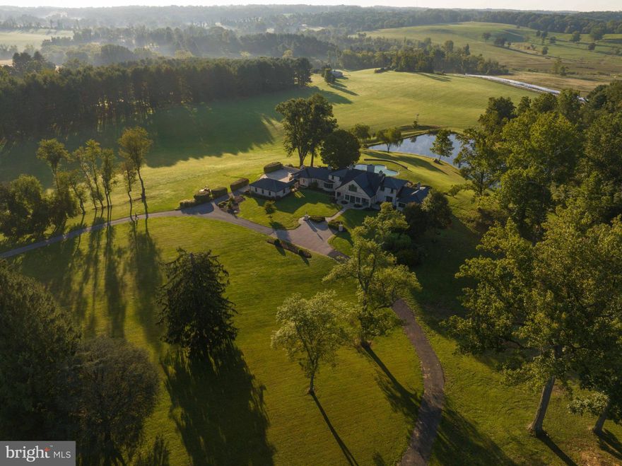 Live authentically. Nestled amidst the lush embrace of pastoral beauty, "The Nest" stands as an architectural masterpiece, evoking the timeless charm of European estates, crowned with a resplendent copper roof. Perched majestically, sweeping vistas overlooking an enchanting panorama that captures the essence of tranquil living—a sprawling pool glistening like a sapphire gem, and an arrowhead-shaped pond that mirrors the azure sky, all set against a backdrop of rolling pastoral hills, their undulating contours weaving a symphony of serenity in the distance.  

As you step onto this hallowed ground, you find yourself living within the very canvas of a pastoral painting. You are immersed in a sensory symphony, surrounded by the graceful and noble presence of grass-fed Roseda beef cattle grazing leisurely in the verdant meadows in the distance. Here, each day unfolds with the promise of a new masterpiece, as the sky is painted... the glorious sunrise and sunset, casting a mesmerizing tapestry of colors that tinge the landscape with ethereal hues. 

In the quietude of misty mornings, when the world is cloaked in a gossamer veil of fog, and when thunderclouds gather on the horizon, you become attuned to the ever-changing rhythms of your surroundings. Nature's theater unfolds before your very eyes, the drama of weather, light, and life, captivating your soul and grounding you in the present.

This estate is more than just a residence; it is a powerful perch, a sanctuary spanning 30.74 acres, anchored by a deeply banked, undulating stream, and graced by a signature sycamore tree, a sentinel to the passage of time. Here, you can picnic by the stream, playfully splash in the pond, and explore the enchanting woodlands that embrace your haven.

Unleash your creative visions here, whether they be to cultivate the ultimate garden of your dreams, to gallop freely across the open fields, indulge in the art of birdwatching, hike through nature's secret trails, or even graze goats.  Mender to the pond, a canoe awaits.  Explore the tranquil waters.  Forge a connection with the elements that surround you.

"The Nest" offers the realization of a lifestyle you've been craving, a big sky haven nestled in the heart of Monkton Hunt Country. It is not just a home; it is an embodiment of dreams, a place where time stands still, and where your soul finds its sanctuary in the ever-changing dance of nature. This is where life transcends the ordinary, and you become part of a living, breathing masterpiece, a testament to the enduring beauty of the world. A once in a lifetime setting. Cultivate your existence. Fox hunting easement to be recorded prior to close. Please book your appointment now. In the event the active date changes, you will be notified.