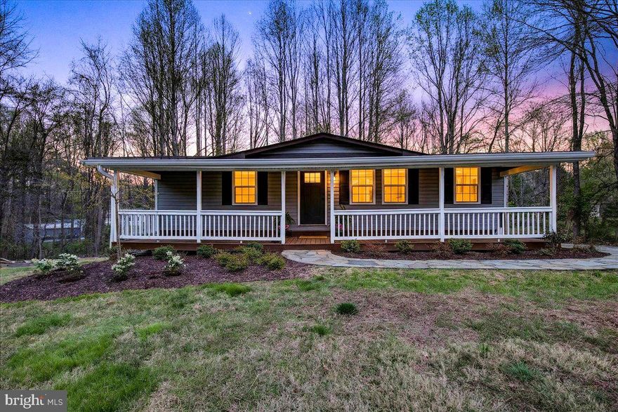 Completely remodeled and thoughtfully reimagined, this two-bedroom, two-bath home offers a warm, inviting interior paired with a layout designed for everyday comfort and effortless entertaining. The main living space features rich flooring, exposed beam ceilings, and a beautifully updated fireplace that creates a natural focal point and adds character throughout.

The kitchen has been upgraded with modern cabinetry, sleek countertops, and a clean, functional design that flows seamlessly into the dining area. Large windows and sliding glass doors bring in natural light and connect the interior to the spacious rear deck, creating an easy indoor-outdoor living experience.

Both bedrooms offer a comfortable, well-appointed feel, designed to provide a sense of retreat and simplicity.

A covered front porch with wood detailing sets the tone from the moment you arrive, offering a welcoming space to relax and unwind. The large rear deck overlooks a natural, wooded setting, providing privacy and a peaceful backdrop.

The unfinished basement presents a valuable opportunity for future expansion, allowing the next owner to create additional living space, a recreation area, or storage tailored to their needs.

The property also includes an assigned deep-water boat slip, making lake access convenient and enjoyable. Located just minutes from Lake Anna’s popular waterfront dining, shopping, and local attractions, and equipped with high-speed internet, this home offers a balanced combination of comfort, character, and potential.