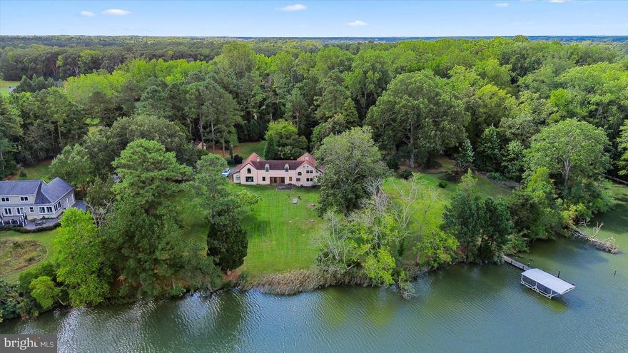 Designed by William Draper Brinckloe, one of Easton’s best early 20th Century architects, this Mission house, “Edgemar”, is nestled on a private 4.5-acre double lot and offers an exceptional blend of character, comfort, and serenity. The property boasts a dock with a highly coveted boathouse (that can no longer be built), a natural shoreline, and mature landscaping highlighted by 100-year-old boxwoods, flowering magnolias, lush hydrangeas, and a majestic 100-year-old oak tree.

This 4,000+ square foot Spanish-inspired home masterfully balances preserved historic features with modern amenities. The gourmet kitchen is a true showpiece, featuring a Miele steam oven, cooktop with barbecue grill, two Fischer Paykal dishwasher drawers, imported Italian ceramic tile, and a custom, cement island topped with an inlaid Chesapeake Bay fossil—perfect for entertaining or everyday use.

The home offers generous gathering spaces including a grand living room, great room, dining area, and cozy library. Period details have been thoughtfully retained, including original heart pine floors, Delft tiles, antique tiles salvaged from Easton’s historic roadways, and a charming antique bar complete with copper sink.

The home boasts two primary suites, one upstairs, and a secret bedroom hidden off the kitchen on the main level, and two convenient laundry facilities.  Upstairs, you’ll find three bedrooms, three full bathrooms including a luxurious spa-like bathroom, two sleeping porches, and a versatile flex space ideal for a home theater, playroom, or den.  The septic system is approved to accommodate 5 bedrooms.

Completing the property are a detached two-bay garage with John Deere lawnmower, circular driveway, and a powered storage shed—offering functionality as well as timeless Eastern Shore charm.  This historic home is rich with character and ready for your personal vision to bring it to life.

Easton, Maryland, known as the New Hamptons of the Chesapeake Bay by Forbes Magazine, is conveniently located 1.5 hours from D.C. and Baltimore, and 2 hours from Philadelphia. Just minutes from fine dining, shopping, healthcare, theatres, galleries, museums, golf courses, a country club, a yacht club, and a jet airport.