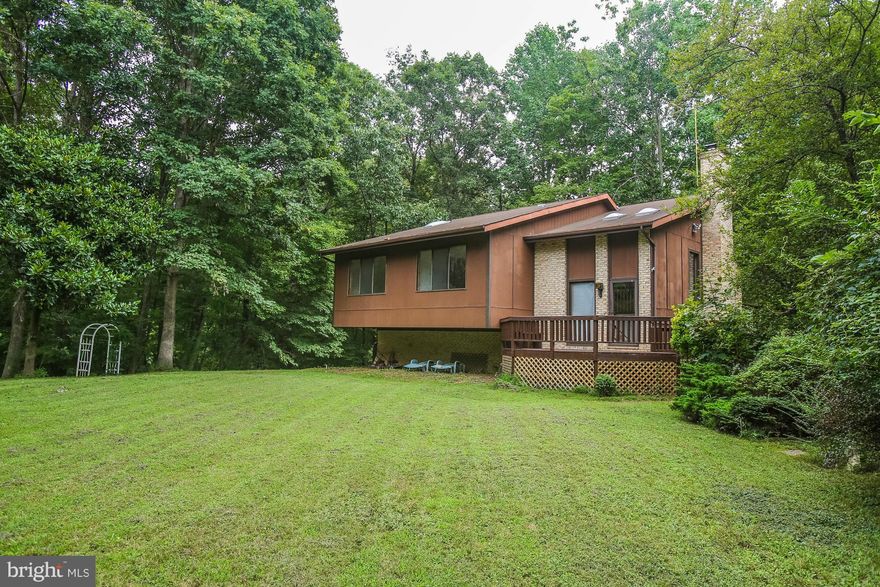 NO HOA! Unique contemporary w/vaulted ceilings & skylights. Lawn surrounded by trees for privacy.   2 miles from shopping. Large driveway. New carpet/flooring. New stove, fridge. Large laundry room has newer W/D, cabinets, countertop, clothes hamper, more. Cedar closet downstairs. Fireplace w/heatilator in living room, wood stove in den.  Huge upper/lower level decks. Convenient to VRE, 95, 66.