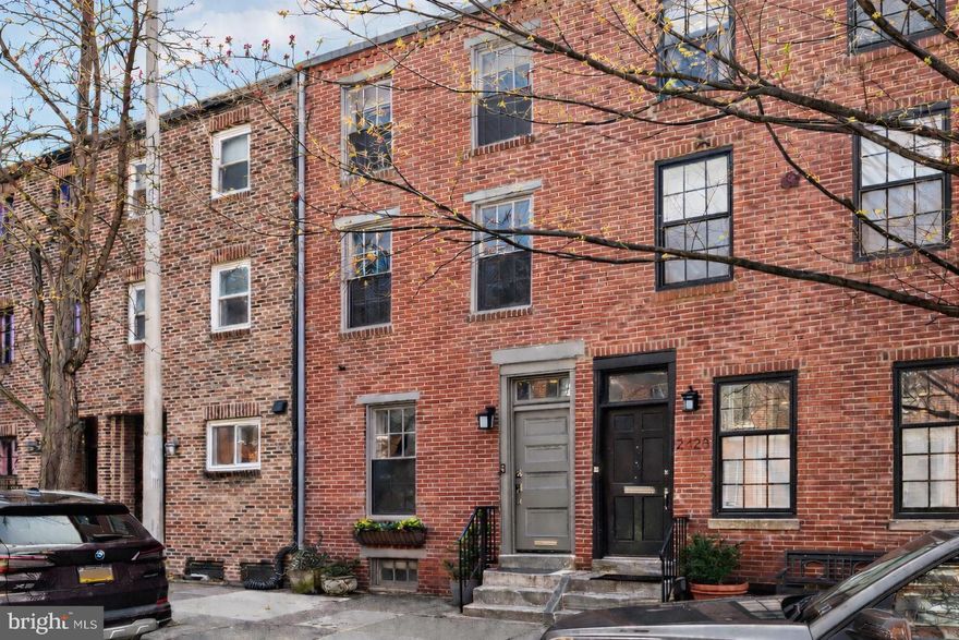 Views of Fitler Square Park from your front door! Built by the owner-developer as their personal residence, 2426 Pine Street offers completely rebuilt construction behind its historic façade. This 4-bedroom, 3.5-bath home features a finished basement, roof deck, and high-end finishes throughout, all on one of the most sought-after blocks in the city. The open and spacious first floor includes a living area, dining space, powder room, coat closet, and striking open steel staircase. The chef’s kitchen is outfitted with abundant white shaker cabinetry, quartz countertops and backsplash, a 36" Viking gas range with commercial vented hood, wine fridge, custom pantry, bar seating, and space for a breakfast table. Pella French doors open to a large rear deck—perfect for grilling and entertaining. The second-floor primary suite features a marble bathroom with glass-enclosed shower and rain head, double marble vanity, walk-in closet plus an additional closet, and French doors that open to a steel balcony overlooking the patio. A second front bedroom on this floor includes its own ensuite marble bath. The third floor offers a front bedroom with vaulted ceilings and tree-lined views, a hall laundry room, and a marble bath with a soaking tub. The rear bedroom features oversized windows and abundant southern light. A full staircase leads to the roof deck with skyline views. Additional features include refinished white oak hardwood floors, heated floors in all bathrooms, Restoration Hardware vanities, Kohler fixtures, recessed lighting, solid wood doors, smart lighting, commercial-grade Wi-Fi, and all new plumbing, electrical, two-zone HVAC, and spray foam insulation on all walls, full bathrooms floors are all heated, roof deck is designed and built to support a hot tub and electric is in place. Seller is offering one year of pre-paid parking located on 24th Street between Walnut and Locust with an accepted offer. Located half a block from Fitler Square Park and steps from the Schuylkill River Trail, Vernick Food & Drink, Rival Bros., and more. An easy walk to Penn, CHOP, Comcast, Rittenhouse Square, and all of Center City.