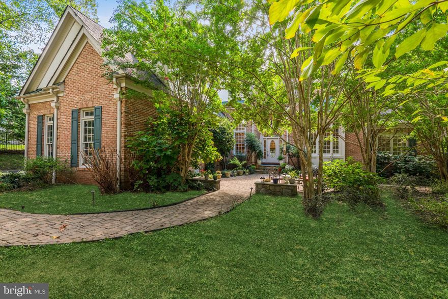 Price Reduced - great value! Offers due 11/15 before 6:00 PM. Lovely custom home on a large landscaped lot, offering a quiet, leafy retreat - and rarely-found true main level primary bedroom suite - in a prime McLean neighborhood of luxury homes, secluded yet close to major roads, shopping and award-winning schools.  Owner has just completed improvements on this 6,000+ finished-square-foot home.  A gated drive leads to the impressive brick residence with elegant arched entryway and large Palladian windows. Spacious and light-filled, the home's open floor plan provides an easy flow through rooms with lofty two-story ceilings and large, beautiful windows. Lovely hardwood floors, elegant moldings, built-ins and custom lighting add elements of luxury to every room, especially the open Living and Dining Rooms, Family Room and Library at its heart. The spacious, updated center isle Gourmet Kitchen has a Breakfast Area and  adjoins the large, comfortable Family Room with access to the outdoor Deck overlooking the grounds. The main level Primary Bedroom Suite offers a spacious retreat with sitting area, built-ins, wonderful walk-in closets and large ensuite Bath. A second Bedroom on the main level enjoys its own ensuite Bath. Upstairs, two additional Bedrooms each have ensuite Baths, and there is generous bonus space for study or play. The entire Lower Level of the house is a large and beautiful, fully-finished above-ground, walkout space providing a full floor of entertaining and recreational space. The Great Room with fireplace  is equipped with a full bar; a Media Room provides for more fun, and a caterer's Kitchen supports the entertainment. A Gym, full bath and Study/5th Bedroom all provide a walk out to the gardens. The fully fenced property includes a 3-car garage, central vacuum, generator, recently-connected public sewer, 3 zones HVAC, many improvements and is offered in excellent condition. The unique and exceptionally beautiful home is located in the Langley school pyramid and is one mile from the Beltway yet very quiet. Don't miss this fine property!