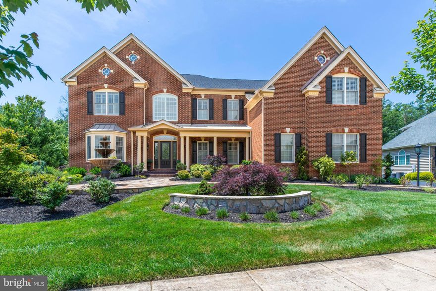 Stunning Estate in Dominion Valley Country Club! Nestled on a private 1-acre wooded lot backing to protected conservation land, this beautifully upgraded home is an entertainer’s dream. The resort-style backyard features over $460K in custom outdoor living upgrades, including a luxury kitchen, stone fireplace, gas grill, fire pit, koi pond, water features, a recirculating fountain, a maintenance-free deck with retractable awnings, extensive hardscaping, and a premium outdoor sound system.

Inside, you'll find 5 bedrooms, 5.5 baths, a 3-car garage, and over 6,700 sq ft of refined living space. The chef’s kitchen features premium cabinetry, Cambria countertops, Wolf and Sub-Zero appliances, and a walk-in pantry. Additional highlights include a sunroom with barnwood ceiling, a family room with a custom stone fireplace, upgraded lighting, plantation shutters, and hardwood floors throughout the main and upper levels.

The luxurious owner’s suite features a tray ceiling, a sitting room, a custom walk-in closet, and a spa-style bath. The fully finished walk-out basement includes an in-law suite, media room, wet bar, game room, and bonus spaces. Other features include a 14-zone irrigation system, a 2022 washer/dryer, and upgraded HVAC systems with UV and electrostatic filtration. Driveway fresh sealed 2025 

Enjoy world-class community amenities: Arnold Palmer Signature Golf Course, clubhouse, sports pavilion, indoor/outdoor pools, tennis courts, walking trails, and top-rated schools!