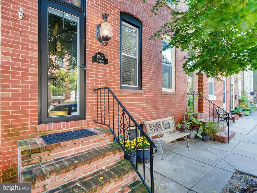 Great price for this fabulous home in prime location!  This home boasts 3 finished levels w/ exposed brick & hardwood floors on main level, as well as decorative fireplace.  Second level has two spacious bedrooms an updated bath with double vanity, as well as laundry and access to 2nd level deck.  Third level features additional bedroom/ family room with wet bar and access to roof deck with water view!  This home has  a parking pad in the rear of property!  *1 year Home Warranty Included*