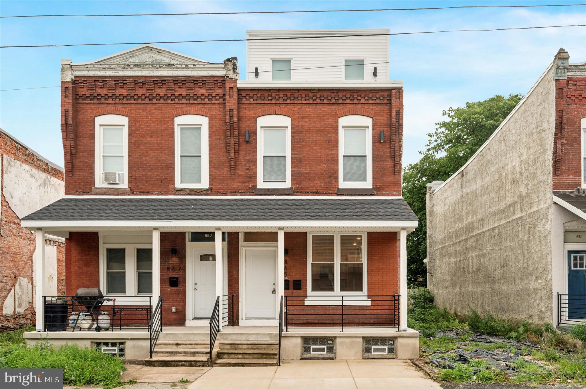 Investors and househackers, listen up! This stylish, recently renovated and expanded duplex in a booming section of Belmont is the definition of a smart purchase. The historic brick-front facade has been respectfully updated with new iron rails and second-story sconces, and this tasteful combination of old-meets-new carries through to the common entryway with large transom window, exposed brick wall and starburst cement tile floor. Both units have great outdoor space, high ceilings with recessed lighting, gorgeous natural light and new maple floors throughout. The spacious bilevel unit is the likely choice for an owner’s unit. Up the private stairs with an exposed brick wall and custom iron railings is the open-plan main living space, where a large living room and U-shaped kitchen are tied together with a beadboard breakfast bar with jute pendant lighting. The kitchen is finished with elongated subway tile backsplash, subtly-veined granite countertops with undermount sink and pull-down faucet, and stainless steel appliances including a five-burner Whirlpool range and Frigidaire dishwasher. Down the hall there’s a full bath with oversize ceramic tile floor; tub with rainhead shower, full-wall elongated subway tile surround; built-in storage and a navy blue storage vanity with herringbone-accented mirror. Past a utility closet with laundry hookups and space for additional storage is the large rear bedroom with three windows and a walk-in closet. The newly added third floor offers an enormous second bedroom, with an even larger walk-in closet and three windows of its own. The bath features a terrazzo hex tile floor and step-in shower with complementing charcoal hex floor, full-wall elongated subway tile surround and rainhead faucet. Finally, there’s access to the rear roof deck with low-maintenance turf. The first-floor unit has the same stylish finishes as the bilevel unit, just in a smaller footprint. Enter into an open-plan main living space, which differs from the upstairs with butcher block countertops and stainless zero-radius sink in the beadboard breakfast bar and a modern stacked tile backsplash. It is followed by a hall bath and a rear bedroom with two windows and access to the downright huge rear yard. This unit also has exclusive access to the basement with laundry hookups and lots of room for storage. Nestled between two commercial corridors–Lancaster and Girard aves–the location offers easy access to neighborhood businesses, trolleys, I-76 and Fairmount Park and is two blocks from a community garden.