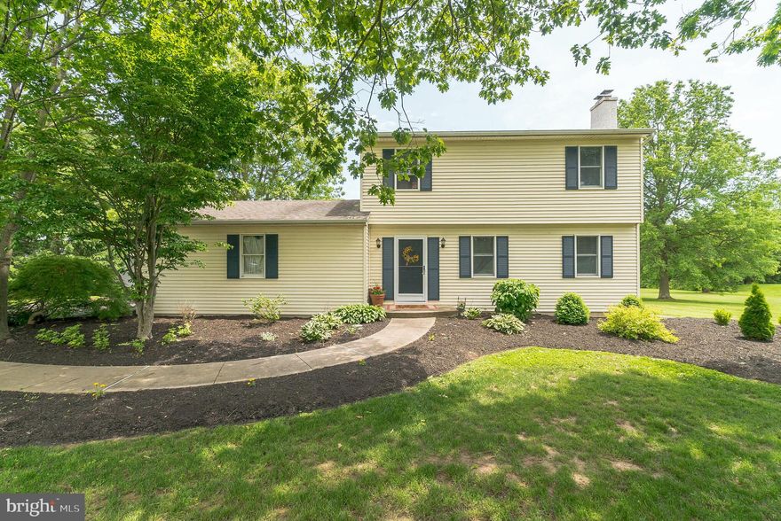 With breath-taking views of Bucks County countryside from every window of this home, this beautiful colonial is tucked in an idyllic setting of shade trees and nature.   The warmth of the free-standing woodstove with attractive brick detail guarantees that the living room will be the ultimate gathering spot; this room boasts hardwood floors, chair rail and crown molding.  The dining room is filled with natural light from a delightful bay window which provides an unobstructed view of the backyard full of birds and wildlife. Bright with white cabinetry and appliances, the kitchen offers a breakfast bar, double oven, ceiling fan, built-in microwave, dishwasher and double sink. The spacious laundry room has an exit door opening to an exceptional 24' X 15'  concrete patio. Since trees and shrubs border the enviable backyard, this is a tranquil retreat for watching the sunrise with your morning coffee.  Three generously-sized bedrooms with hardwood flooring and a ceiling fan in each plus a roomy full bath complete the 2nd floor.  An attractively-placed 19'  X 13'   outbuilding  with electric and double entry doors provides ample room for lawn maintenance and recreational equipment.    You can park 10 or more cars on the remarkable long driveway with turnaround, so large backyard barbeques are easy to host!   Looking out the front door, there is an open field across the street and behind this lot is another field - it just doesn't get more picture-perfect than that. Special features include welcoming curved front walkway, six-panel doors and easy-to-maintain flooring throughout the home, main-floor powder room, two-car side-entry garage with built-in cabinets and some recently-replaced windows. It's only an eight minute ride to the Chalfont Train Station and only twelve minutes to enjoy all the charming shopping and delicious restaurants for which Doylestown is known.  Within walking distance of Tabora Farms and just a quick ride to Peace Valley Park, this property is located in the highly-regarded Central Bucks School District.   This homesite is very special and needs to be seen to be appreciated.
