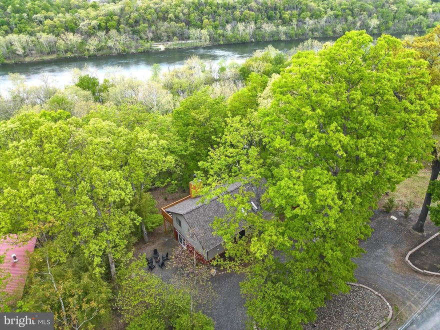 Enjoy breathtaking views of the Shenandoah River from this idyllic cabin in the woods! This nearly 3-acre slice of Harpers Ferry heaven offers private river access and 3 bedrooms/2 bathrooms within 1,800+ light-filled square feet. Special features include an open-concept floor plan, stone-cladded wood-burning fireplace, well-appointed kitchen, updated primary bathroom, vaulted ceilings, gleaming hardwood floors, and a spacious deck for appreciating the gorgeous surroundings. Thanks to its ideal location, it’s the perfect place for full-time living or weekend getaways alike. Outdoor enthusiasts will love the river activities, hiking trails, and other local adventures. Historical attractions and various amenities within close proximity make it a desirable place or both live and visit. Plus the Blue Ridge Acres community offers both river access and a community pool. With outbuildings for storage and ample parking, this lovely cabin within minutes of Rt. 340 and Rt. 9 has so much to offer. *Brand new HVAC system, and the roof is less than 5 years old. This property is an active AirBnB and can only be shown on weekdays in between reservations.  Please see documents for what conveys with the property, including a brand new hot tub (not currently installed).*