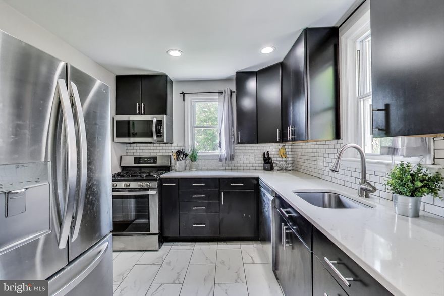 ***$10,000 Welcome Home Grant available.  Please contact agent for more information!***

Welcome home to historical Hyattsville! This updated 3 bedroom, 3 bathroom detached home has an unbeatable location, and a rare opportunity for multiple living spaces. Inside the front door, the inviting family room features gleaming hardwood floors and boasts a wood-burning fireplace with a classic brick surround, while the adjacent dining room includes a bay window and elegant crown molding. The bright, remodeled kitchen offers abundant cabinetry, stainless steel appliances, sleek quartz countertops, and a timeless subway tile backsplash. A laundry room and a fully updated bath complete the main level. Upstairs offers two generously sized bedrooms with ample closet space and a second full bathroom. The lower level presents a rare opportunity for multigenerational living with a private suite complete with a kitchenette, full bathroom, and a separate entrance from the backyard. Enjoy outdoor living with a covered deck and a large, flat backyard that backs to trees - perfect for relaxation, gardening, or play. Ideally located just minutes from Aldi, Whole Foods, Walmart, the Arts District Hyattsville, Northwest Stadium, Fletchers Field, and several major universities including Catholic, Gallaudet, Howard, and UMD. Excellent commuter location with quick access to the Baltimore-Washington Parkway, Kenilworth Ave, Route 1, and multiple Metro stations including Hyattsville Crossing, New Carrollton, College Park, and West Hyattsville.