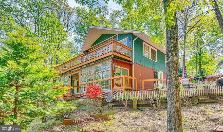 HUGE $15,000 REDUCTION! Tucked away on a peaceful cul-de-sac in Lusby’s sought-after Chesapeake Ranch Estates, this one-of-a-kind rambler combines rustic charm with thoughtful design and modern comfort. With vaulted, tongue-and-groove ceilings, warm hardwood floors, and an open-concept main living area, the interior welcomes you with style and space. Wainscoting details add a classic touch, while large, light-filled rooms offer room to relax, entertain, or create your dream work-from-home setup.

Step outside to your private backyard oasis—perfect for gatherings or quiet evenings under the stars. An oversized wraparound deck, paver patio, firepit area, and covered cabana set the stage for summer barbecues and serene mornings with coffee. Need flexibility? This home also features a second kitchen area for added convenience or hosting ease.

Living in Chesapeake Ranch Estates means more than just owning a beautiful home—it’s a lifestyle. Residents enjoy access to both bay and lake beaches, a neighborhood playground, and even a private airstrip. Just minutes away, you’ll find the charming waterfront town of Solomons Island, known for its marinas, restaurants, boardwalk, and events. With quick access to Patuxent River Naval Air Station and all the shops and dining of nearby St. Mary’s County, you’ll love the balance of nature, community, and convenience.

Whether you're looking for space, amenities, or a touch of the unique—this home has it all.