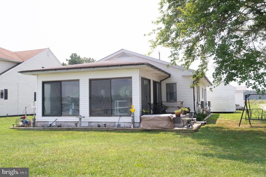 NEW PRICE!! AFFORDABLE WATERFRONT!  Enjoy the wide water view from this cute cottage just minutes from Cambridge! All season room with sliders and a deck.  Eat in kitchen, living room laundry room, back enclosed porch.  Check out the custom "liquor closet" .  Nice dock with electric and water  with jet ski lift. Clean your catch of the day at the fish cleaning table.  Protected shoreline.  
No septic worries - property is tied into the Sanitary District.