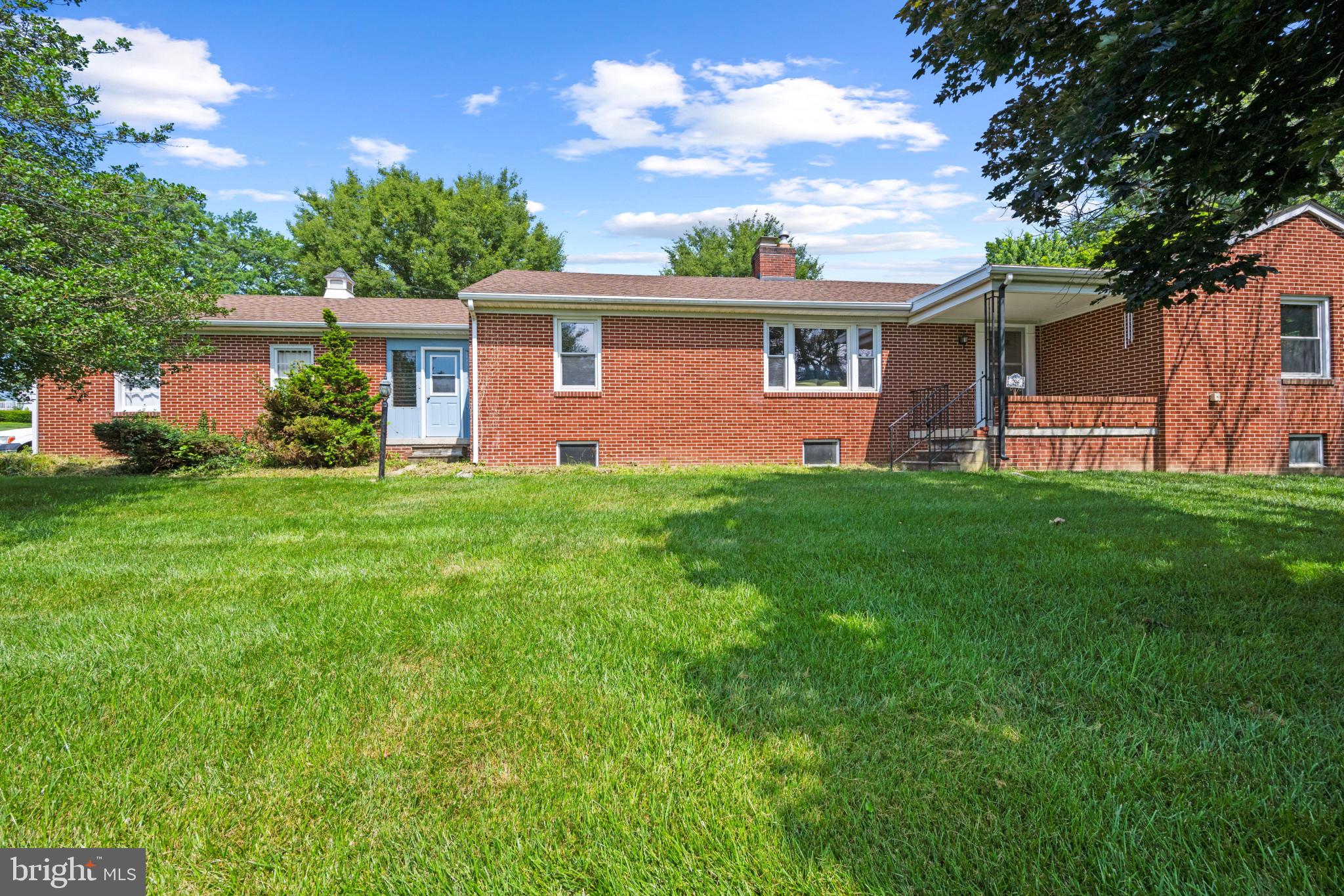 Don't just imagine it, come see this Delightful Brick Rancher in the Heart of New Windsor for yourself. This lovingly cared-for all-brick rancher offers the perfect blend of comfort, space, and small-town charm, ready for you to move in and call it home. Inside, you'll find 3 generously sized bedrooms, 3 full bathrooms, and a floor plan that flows with ease. The open kitchen is perfect for casual meals or weekend baking marathons, and the double-sided wood-burning fireplace brings cozy vibes to both the kitchen and living room. Gorgeous hardwood floors, custom built-ins, and large windows give the home character and warmth throughout. Everything you need is on the main level—including laundry—making everyday living a breeze. Need more room to spread out? Head downstairs to a large family room ideal for spending quality time with loved ones. A gas stove will keep you toasty warm when cold winter days arrive. The downstairs also offers a third full bath in the unfinished area , a workshop, plenty of storage, and more space to create your next favorite spot. Outside, enjoy peaceful mornings or laid-back evenings on the covered patio overlooking your ample yard—great for entertaining, gardening, or simply relaxing.
Tucked into an established neighborhood and just minutes from local shops, cafes, and community events, this home is your invitation to be part of a wonderful community and enjoy life. Schedule your private tour today, and be ready to fall in love with the charm, style, and comfort of this home.