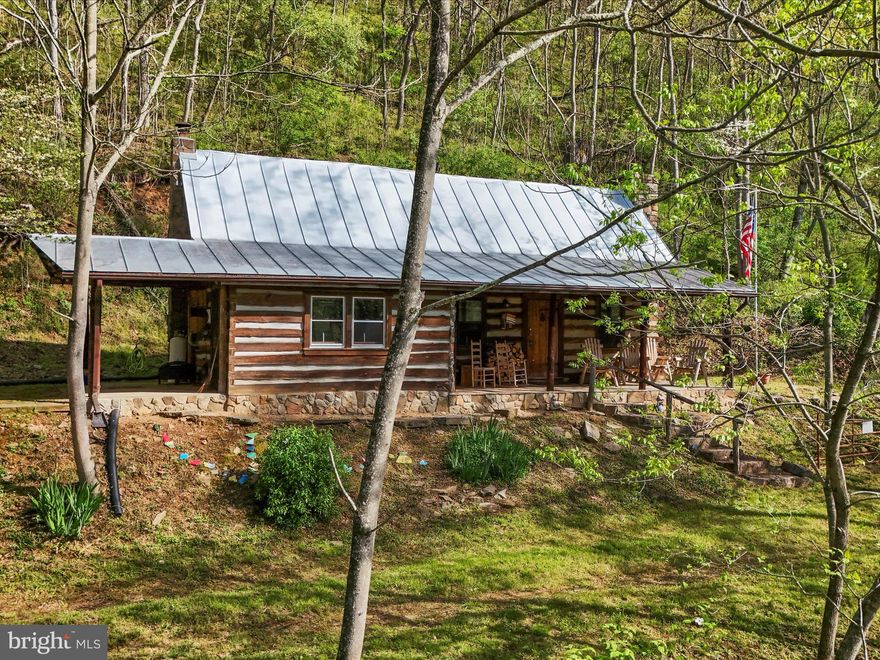 A FAMILY TREASURE IS NOW BEING OFFERED FOR SALE. THE FIVE UNRESTRICTED ACRES WHERE THE LOG CABIN WAS BUILT HAS 500' OF RIVER FRONTAGE. THE PRIVATE SETTING GIVES A FEELING OF SERENITY. IF NOT ENJOYING THE RIVER, TAKE YOUR CHOICE OF ENJOYING THE OUTDOOR LIVING SPACES ON EITHER THE FRONT OR SIDE COVERED PORCHES. THE LOGS USED TO CONSTRUCT THE HOME WERE SHIPPED IN FROM VIRGINIA 40 YEARS AGO. A STONE WOOD BURNING FIREPLACE IS THE CENTER PIECE OF THE LIVING ROOM AREA. THERE IS A MURPHY BED IN THE LIVING ROOM AND A LOFT TO UTILIZE FOR SLEEPING SPACES. THE KITCHEN IS OPEN TO A DINING AREA. THERE IS A FULL BATHROOM ON THE MAIN LEVEL. THE CABIN SITS AT THE BOTTOM OF A HILLSIDE WITH YARD SPACE TO ENTERTAIN AND RELAX. THIS PROPERTY WILL REQUIRE APPOINTMENTS TO TOUR AND PLEASE NO DRIVE-BYS. THE PRIVATE SETTING IS LESS THAN 15 MINUTES AWAY FROM RESTAURANTS, GAS STATION AND A DOLLAR GENERAL FOR SHOPPING. THE ELECTRIC PANEL UPDATED IN 2018. NEW ROOF INSTALLED IN 2020. THE LOCATION IS AN EASY DAY TRIP FROM WASHINGTON D.C. AND LESS THAN AN HOUR FROM WINCHESTER, VA! JUST IN TIME FOR THE SUMMER!