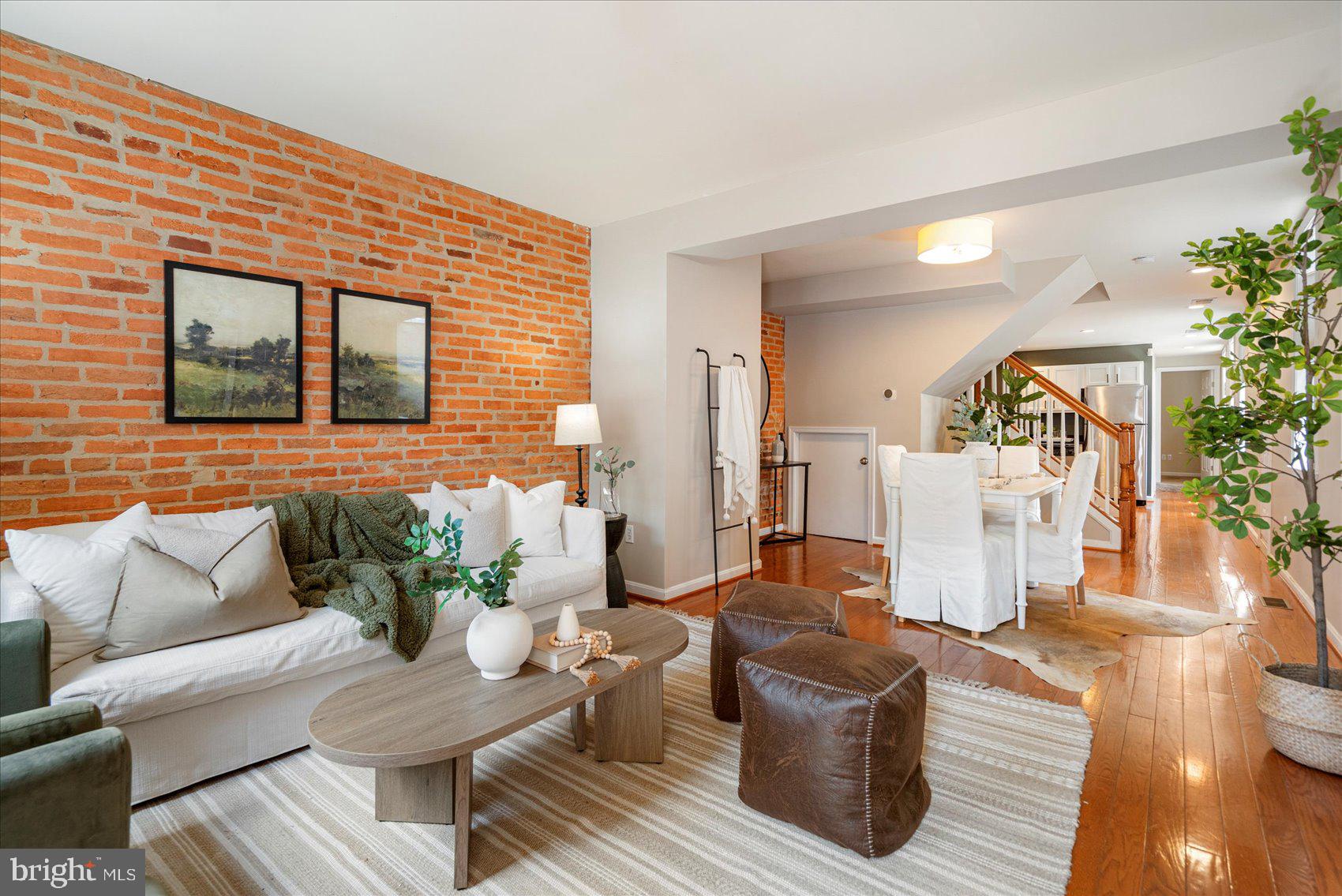This is a true gem in the sought after Fells Point Historical District! A beautiful, end-of-group rowhome equipped with city charm and loads of upgrades. The Baltimore signature brick accent wall extends from the living room to the kitchen. Natural light floods each room through the row of windows that extend the entire side wall. Tucked behind the kitchen are a full bathroom, washer/dryer, and an additional room to serve as a den, office, or additional bedroom.
Ascend to the sunlit hallway of the second floor. To the left is the primary bedroom with a walk-in closet and king-sized ensuite. To the right is another spacious bedroom and full bathroom.
Beautiful hardwood floors, recessed lighting, and updated appliances are just a few more of the many perks this home has to offer. Don't miss your chance to call it home.
