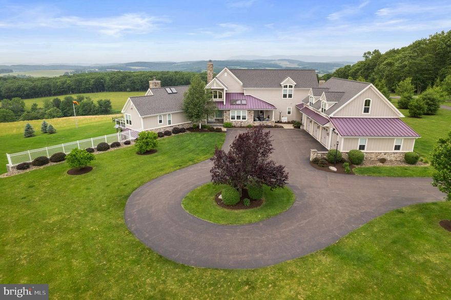 As I make my way up the long scenic driveway, I am immediately captivated by the charm of this property. The lush greenery, the well-manicured landscape, the panoramic views, and the welcoming facade set the stage for something truly special. This could be my perfect vacation home, farm, bug-out spot, or primary residence. Stepping inside the home, the first space I see is the incredible family room. The family room offers stunning views, wooden beams and a grand stone fireplace. Off the family room is the kitchen which is definitely the heart of the home! It is truly a Chef's Kitchen with white cabinets, tile backsplash, granite countertops, a six-burner stovetop, a Sub-Zero Pro 40 refrigerator, built-in wall oven and microwave, an induction cooktop and steamer, an expansive island and a walk-in pantry. The quaint dining room is tucked behind the kitchen and I plan to host the holidays this year knowing that I will be able to fit all my family and friends around the table! After a long day, I am looking forward to retreating to my master suite. My master suite is on the first floor and offers a ton of natural light, long distance views of the property, a fireplace, a coffee bar with sink, walk-in closet, a full bathroom with jetted tub, stall shower, and lovely wood built-ins. The master bedroom has its own private porch with a staircase leading to the back yard. On the opposite side of the house is an additional bedroom offering its own full bathroom. This bedroom will be perfect for my guests who stay for extended visits that appreciate being on the main level! Prior to heading to the second floor, I can't forget to mention a few other key features of the first floor. The first floor offers a cozy sunroom with skylights, a half bathroom and a spacious laundry room. Ascending to the second floor, there are two additional bedrooms and a full bathroom. I love how spacious the rooms are and the abundance of closet space! On the lower level, the basement provides an incredible amount of storage space. In the future, I might turn this into a media room, home gym or a spot to work on my hobbies. Stepping outside, the attached four-car garage will provide my vehicles with a safe place from the harsh weather. There is also an additional 900 square feet of open space above the garage that could be finished off or used for storage. The 72'x40' pole barn is another space I can't wait to utilize! It offers over 2,800 square feet with 14ft ceilings over a concrete floor, a 12x12 overhead door, a 24x12 split sliding door, and 400amps of electric service. The property is truly stunning with over 100 acres of woodlands, fields, and wildlife, and I look forward to ending my days relaxing on the back patio taking in the views. A few other important features are the water system that has a UV light, updated landscaping, a fenced in backyard, and a 22KW water cooled emergency generator. I have found my own slice of paradise, and I can't wait to move in!