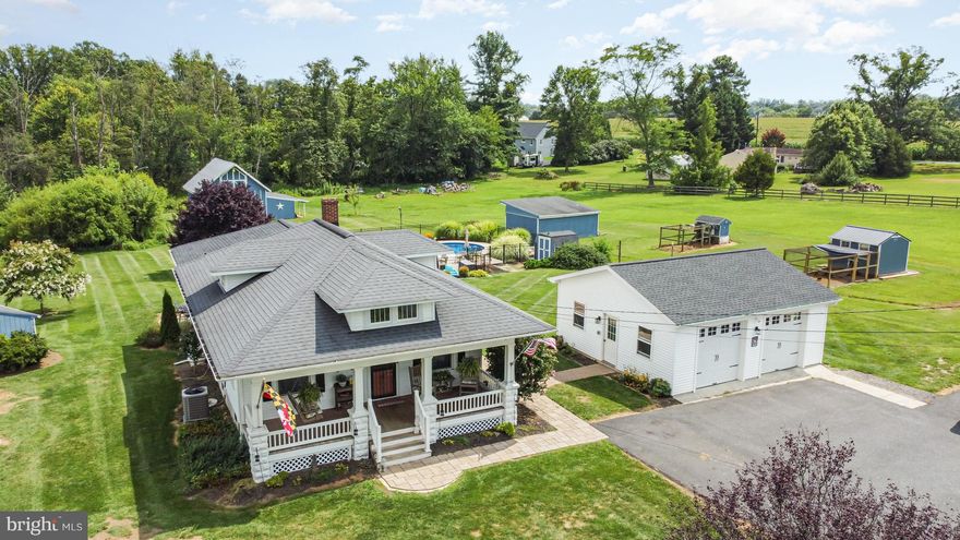 Fantastic 5 acre farmette with so much character and opportunity!  This amazing Craftsman/Bungalow Style home offers a gorgeous front porch,  3 Bedrooms and 1.5 Baths and updates inside and out!   The living and dining room have tall ceilings, a gas fireplace and a passthru to the kitchen! The kitchen has solid surface counters, stainless appliances and lots of cabinet space!  The lower level has a  recreation area, laundry room, office space and  plenty of storage!  You can walk right out to the beautiful paver patio and look out on the expansive property!  The roof, hvac, windows, kitchen have all been updated!  As impressive as the inside is, you’ll be excited to know that there is a 5 Stall barn with a tack room and loft,  a 2 car detached garage, a beautifully updated inground pool, outbuildings, established gardens, a green house, chicken coop  and a  produce stand all on level land!   Perfect for homesteading  or a hobby farm!   This is one property you don’t want to miss!  A list of updates and upgrades is available!