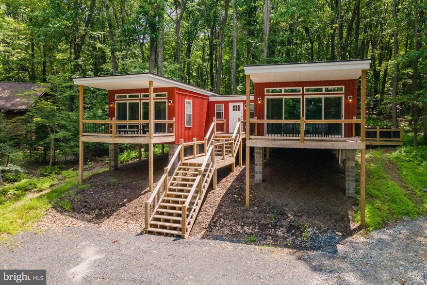 Looking for economical retreat at Deep Creek Lake? Look no further! Recently completed in 2021, with a modern “shipping container” vibe that feels more like a luxury tree house than a mountain home. Situated on an acre of wooded land, this 2 bedroom 1.5 Bath is brilliantly designed to create a stylish and comfortable environment, with a modest floor plan. Two front balconies with tranquil filtered lake views, Large back deck with a newer hot tub and private stone firepit provide lots of scenic and relaxing outdoor living space. Established Vacation Rental, “Escape Inn” is located on Lake Shore Drive, minutes from local establishments, marinas, state parks and Wisp Resort. Don’t miss your chance to see this one of a kind showpiece in the heart of Deep Creek Lake…. Call today for details!
