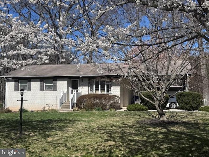 Nestled on a serene, tree-lined lot just under a half acre, this charming rambler offers the perfect blend of peaceful living and everyday convenience. Surrounded by mature trees and located on a quiet street lined with beautiful cherry trees, this 3-bedroom home is filled with warmth, character, and opportunity.

The main level features hardwood floors throughout, a spacious Living Room with a cozy wood-burning fireplace, and a Kitchen with newer appliances. The Dining Area opens through sliding glass doors to a deck overlooking the lush backyard — an ideal setting for morning coffee, outdoor dining, or simply enjoying the tranquil scenery.

The finished walkout lower level expands the living space with a large Recreation Room featuring sliding doors to the backyard, a versatile Bonus Room, a half bath, Laundry Area, and plenty of storage.  The attached 2-car carport provides easy covered parking and additional practicality.

Nature lovers will appreciate being within walking distance to Seneca Creek State Park, where you can enjoy the lake, scenic trails, and abundant wildlife. Despite its tucked-away setting away from all of the hustle and bustle, this home is conveniently close to shopping, restaurants, schools and commuter routes - Great Seneca Highway, 270, Sam Eig Highway and the ICC.

With solid bones, timeless charm, and endless potential, this lovingly maintained home is ready for its next Owner to bring their creativity, personal touches, and new memories to life.