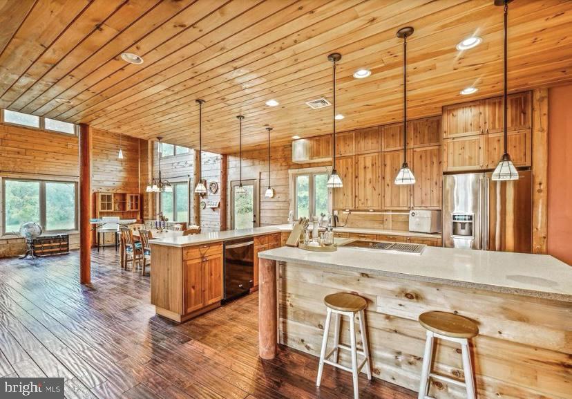 Truly One-of-a-Kind Custom Cedar Log Cabin – A Rustic Dream with Modern Perks!
Welcome to your private slice of serenity! This meticulously crafted custom cedar log cabin is more than a home—it’s an experience. Built with heart, precision, and thoughtful detail, this stunning sanctuary blends rustic charm with cutting-edge efficiency.
Energy-Smart & Whisper-Quiet:
Constructed with energy-efficient cedar logs, this home is estimated to be 40% more efficient than traditional builds—keeping utility bills low and comfort levels high!
The naturally soundproofed interior and added acoustic insulation between floors create an oasis of calm inside.
Warmth That Radiates:
Stay cozy year-round with hydronic radiant floor heating on both the basement and main level!!
Need a little extra warmth or ambiance?
The gorgeous, anti microbial soapstone woodstove not only adds charm but also delivers powerful heat retention. (Instructions and cleaning guide included—plus some wood is already stacked and ready!)
Superior Basement, Ready to Finish:
No worries here—this basement is built with Superior Walls for dryness and longevity. Already plumbed for a bathroom and sump pump, with egress-sized windows, multiple heating zones, and exterior Bilco door access, it’s a blank canvas for your dream lower level.
Garage-Ready:
Foundation is already in place for a 2-car garage, and matching log siding is conveniently stored in the basement—finish it to match the home seamlessly!
Innovative Electrical Design:
Taking advantage of forward-thinking tech, most outlets are installed in the floor to preserve the integrity of the log walls, and many light switches are wireless.
Stylish, Functional Interiors:
• First Floor: ¾” hand-scraped Oak flooring with stone tile in entryways and ceramic tile in bathrooms
• Bedrooms & Pantry: Durable engineered wood flooring
• Second Floor: ½” Australian Cypress flooring for that luxe, warm glow
• Bathrooms: Ceramic tile
Kitchen: Beautifully crafted open kitchen featuring Solid surface Corian countertops, island rough-plumbed for a second sink or pasta filler, and GFI outlets at both ends.
Tech-Friendly Touches:
Cable access and phone jacks in all bedrooms, the loft, and the great room make staying connected a breeze.
Outdoor Extras:
Multiple GFI outlets under windows and at the front/back entrances make holiday lighting and outdoor projects super simple.
Some TLC Needed – Opportunity Awaits:
• Paint touch-ups in the Mudroom, Loft, and Primary Suite
• Trim pieces and materials for finishing doors and windows are on site and ready for install
• Some windows have lost their seals and may benefit from replacement—one in the Great Room has a minor leak
• Bi-fold closet doors needed in select spaces
Ready to bring your rustic luxury vision to life? This cedar beauty is packed with potential and already bursting with character. Do Not miss your chance to make it yours!
