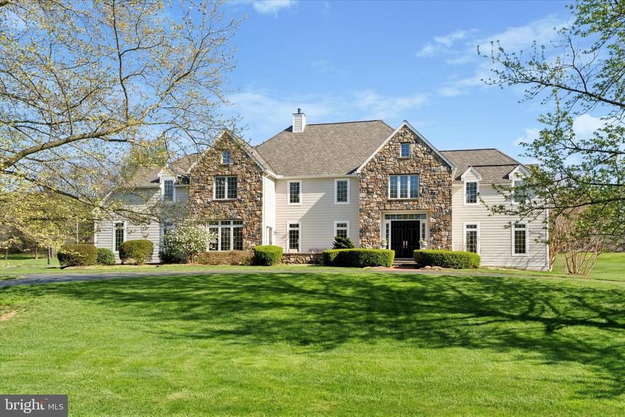 Experience luxury, space, and sunset views at this meticulously maintained home bathed in natural light with charming transom windows that add architectural interest and a bright, airy ambiance.  Featuring exceptional finishes and thoughtful upgrades throughout.  Pull up to the circular driveway of this stately Hardie plank and stone home, a testament to quality and curb appeal.  Step inside to find convenient coat closets flanking either side of the entryway.  This elegant residence features a two-story terrazzo foyer and grand staircase that sets a sophisticated tone from the moment you enter the double front doors.  Beautiful, Brazilian cherry hardwood floors carry throughout the main living spaces, home has been freshly painted in Benjamin Moore's Winds Breath, complemented by all-new LED recessed lighting.  The formal living room is an inviting retreat with a marble-surround propane fireplace, while the adjacent executive office includes built-in bookcases and recessed lighting - perfect for working from home.  The dining room opens to a stunning front slate patio where you'll enjoy breathtaking sunsets, and connects to the kitchen via swinging doors for seamless entertaining.  The kitchen has black granite countertops, premium Charles Goebel & Sons cabinetry, glass-front pantry cabinets, under cabinet lighting, appliance garage, new black hardware, new kitchen faucet, DACOR cooktop & convection oven, and SubZero refrigerator.  The breakfast room has a wet bar with granite counters and glass front cabinets with under cabinet lighting and a built in work/desk area with cabinetry.  The eat-in area opens through double doors to a slate patio with pergola, ideal for al fresco dining.  Relax in the family room with a stone fireplace, recessed lighting, and ceiling fan.  Two half bathrooms on each side of the home, 1st floor laundry/mudroom, with cabinets, and laundry sink, and 3-car garage access offer practicality and ease.  A rear staircase provides alternate access to the upper level.  The primary suite is a true oasis with a sitting area, ceiling fan, walk-in closet, recessed lighting.  Wait until you see this incredible, newly renovated primary bathroom, picture yourself unwinding after a long day in the spa-quality primary bathroom which features dual 48" vanities, lighted mirrors, Moen fixtures, freestanding soaking tub, walk-in shower with custom seamless glass enclosure, rain shower head, pebble shower floor.  Bedroom 2 has double closets, and a ceiling fan.  Third bedroom with ceiling fan, double closet, and a Jack & Jill bathroom.  The fifth bedroom is filled with natural light, has a walk in closet, a reach in closet and access to the walk up attic for additional storage.  The finished lower level features new carpeting with upgraded padding, movie room, recessed lighting, and a unique brewing-themed space in the unfinished area, plus excellent storage throughout.  Modern comforts include NEST 2-zone HVAC, brand new primary bathroom (2025), Hardie Plank siding (2022), new architectural shingle roof (2022) and all updated interior fixtures and LED lighting.  Enjoy those summer nights on the slate patio with a pergola with lights.  This home is not only impeccably maintained, but also ideally designed for both everyday living and elegant entertaining.  Don't miss your chance to own this spectacular, move-in-ready home with timeless design and unforgettable views.  Close to Kennett Square Golf Club, Sovana Bistro, Longwood Gardens and other fabulous restaurants and shopping.  I promise you will not be disappointed with the care and updates that have been made to this home.  Located in the prestigious Unionville-Chadds Ford School District.  All you need to do is unpack your bags!