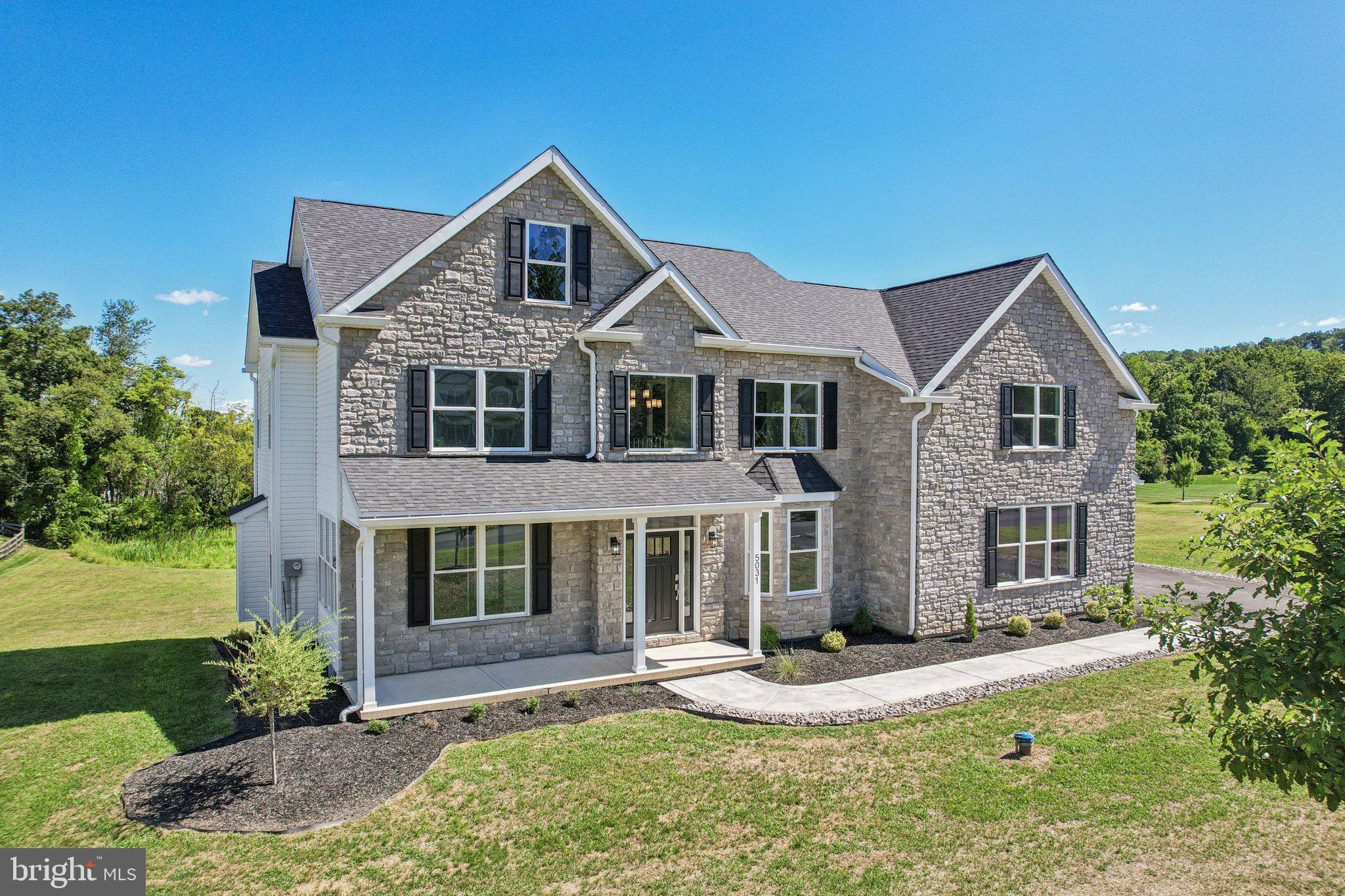 Welcome to your dream home in Stone Ridge Estates, offering brand-new construction without the wait, nestled on 2.3 acres on a quiet cul-de-sac. Enter into a grand 2-story foyer to be greeted with OAK WOOD FLOORING, soaring 9-FOOT CEILINGS, recessed lighting, and exquisite custom trim work including crown molding, chair rail and wainscoting. A formal living room flows through French doors into a cozy family room, anchored by a stone-faced FIREPLACE. The eat-in kitchen showcases an island, a pantry, granite countertops, and direct access to the 12x32 deck, complete with lighted posts and a ramp leading to the driveway. A formal dining room, half bath and access to an oversized 35x24 3-car garage complete the main level. Upstairs, you’ll find 4 huge secondary bedrooms, each outfitted with ceiling fans, sharing a full hall bath with a skylight. Conveniently situated is a laundry room that then leads to the MASSIVE PRIMARY SUITE boasting oak wood floors, vaulted ceilings and 3 WALK-IN CLOSETS. The luxurious ensuite features a dual vanity, soaking tub, large open shower, separate dressing area and skylight. The 3rd level offers a huge BONUS ROOM, ideal as a 6th bedroom, home office or rec room, with its own full bath. The full basement walks-out to the spacious 32x24 patio and is ready for your finishing touches already plumbed for a full bath and designed for a future wine cellar. This is more than just a home, it's your opportunity to enjoy luxury and space in a prime location.