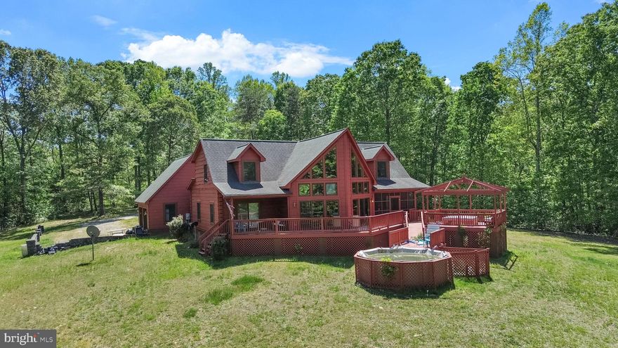 Private 10.25-Acre Retreat for the Sportsman, the Entertainer, and Everyone In Between
3 BR + Office + 2 Bonus Rooms · Garage · Pool · Hot Tub · Dog Kennels

Tucked away on over 10 private acres, this remarkable property is as versatile as it is beautiful. Whether you're a sportsman seeking the perfect hunting base, a family craving space and privacy, or an investor eyeing short-term rental potential, this one checks every box.

The land is a sportsman's dream, offering ample acreage for food plots, tree stands, or blinds, with professionally built dog kennels already in place for working dogs and hunting companions. The garage provides generous space for equipment, ATVs, or a workshop, and the surrounding acreage delivers the kind of seclusion that serious outdoor enthusiasts look for.

Step inside and be immediately drawn to the dramatic A-frame windows that frame sweeping views of the lush backyard, flooding the main living area with natural light. The main-floor primary suite is a true retreat within a retreat, featuring a private screened-in porch perfect for early morning coffee before the hunt, flowing out to an expansive deck built for gatherings. A beautifully appointed en suite bath completes this first-floor sanctuary.

Ascend the charming spiral staircase to discover a stunning loft and two oversized bonus rooms, each large enough to bunk a full hunting party, host family and guests, or serve as entertaining space. A dedicated office on the main level adds flexibility for remote work or planning your next outing.

After a long day outside, unwind in the above-ground pool, soak in the hot tub, or gather around the large deck as the sun sets over your acreage. This property knows how to work just as hard as it plays.

With its rare combination of land, privacy, amenities, and flexibility, this property is a must-see. A forever family home, a sporting retreat, a short-term rental destination, the possibilities here are truly limitless.