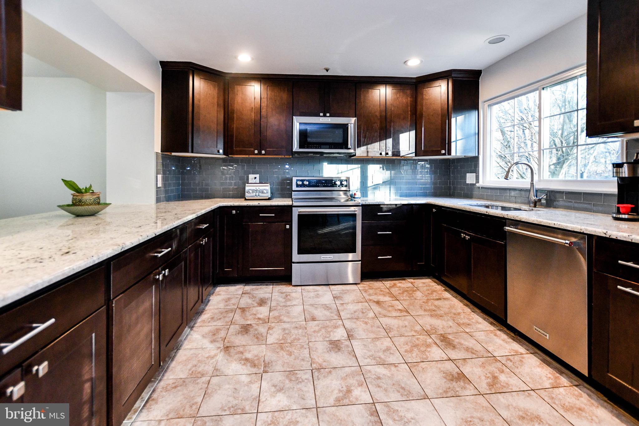 Buyer couldn't secure financing- Appraises at $430,000- Beautiful Newly Renovated End Unit Townhome-Won't Last Long. This 3 level, 4 bedroom and 3 bathroom townhouse has it all. New carpet, new paint, renovated kitchen and bathrooms. Very clean and well maintained home. Hardwood floors throughout the main level and granite countertops make this home a delight. The spacious open layout on the main level which opens onto your deck overlooking a wooded backyard for privacy. The one car garage provides ample storage space and the basement level can function as a 4th bedroom, office space, or in -law suite. Come view this lovely home.