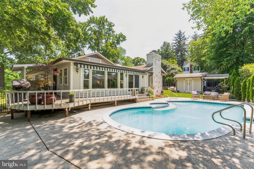 Tucked away on a quiet cul-de-sac, this beautifully landscaped 3-bedroom, 4-bath rancher offers exceptional indoor-outdoor living, generous parking, and a level of craftsmanship rarely found. Originally built by a builder for his own residence, the home blends thoughtful design, abundant natural light, and extensive updates throughout. A covered front porch and expansive private driveway accommodating 6–7 vehicles, along with a carport, create an inviting and practical arrival. Inside, rich hardwood floors flow through the main living areas, setting a warm and elegant tone. The fully renovated kitchen is the heart of the home, featuring quartz countertops, soft-close cabinetry and drawers, stainless steel appliances, gas cooking, a skylight, and a striking 12-foot island with breakfast bar—perfect for everyday living and entertaining alike. Adjacent to the kitchen, a cozy sitting area showcases an all-brick wood-burning fireplace, recessed lighting, and seamless circulation for gatherings. The formal dining and living rooms are highlighted by double crown molding and chair rail detailing, offering timeless sophistication. A stunning, light-filled sunroom with hardwood floors, crown molding, and dual ceiling fans opens through a beautifully stained wood slider to the freshly painted wraparound deck, overlooking the fully fenced and gated built-in pool—an entertainer’s dream. The main-level primary suite provides a private retreat with hardwood flooring, dual closets, a convenient laundry closet with newer washer and dryer, and a luxurious en-suite bath featuring a bidet, ceramic tile flooring, porcelain tile shower surround with glass enclosure, granite vanity, and custom mirrored storage. Two additional bedrooms on the main level offer ample natural light, crown molding, and thoughtful storage, including a separate entrance from the driveway for one bedroom—ideal for guests or a home office. A stylish full hall bath completes the main level. The fully finished lower level expands the living space with a large recreation room featuring recessed lighting, engineered wood flooring installed in 2023, and a new walk-up stairway to the side yard. This level also includes a guest room with luxury vinyl plank flooring, a full bath, stacked washer and dryer, second refrigerator, and abundant utility and storage space. Outdoors, the property truly shines. The concrete deck, built-in pool with Jacuzzi, and charming pool house with a full bath and shower create a resort-like setting for relaxation and entertaining. Pool equipment is thoughtfully maintained, with a new pump and updated piping. Additional updates include some newer windows; one in the kitchen and all in the basement  (2017),  an updated HVAC system, fresh interior paint throughout, new professional chimney pointing, and added attic insulation. With its exceptional layout, abundant natural light, and impressive amenities, this home offers a rare opportunity to enjoy privacy, comfort, and elegant entertaining—all just moments from everyday conveniences. Conveniently located just minutes from Downtown Silver Spring, this home offers easy access to an exceptional mix of shopping, dining, and entertainment, including restaurants, cafés, the AFI Silver Theatre, The Fillmore, and major retailers. Outdoor enthusiasts will appreciate nearby Rock Creek Park and Sligo Creek Trail for hiking, biking, and recreation. Commuters benefit from quick access to Silver Spring Metro (Red Line), MARC, I-495, and major routes into DC, Bethesda, and beyond—making this a prime location that blends suburban tranquility with vibrant urban convenience.