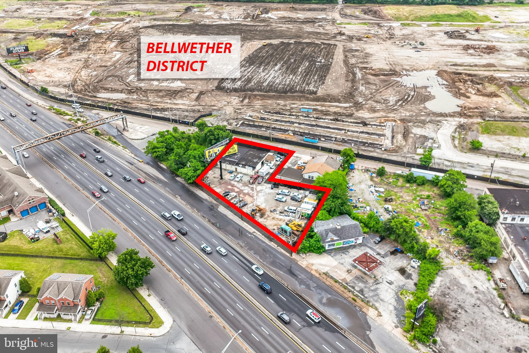 CONSTRUCTION HAS STARTED IN THE BELLWETHER DISTRICT. Get in at ground level! Amazing investment opportunity in the red-hot Bellwether District! Street-to-street access: Two parcels consisting of .55 acres. V sign lease income of $2,041.67 per month, 4 years left on the lease. The V sign may go digital, with double rent and value possibilities. In addition to rent, the sign company pays the seller $9,800 per year towards real estate taxes. There is a 5,200+/- warehouse with 1 spray booth, 1 large storage area, 2 lifts, 2 offices, a kitchen area, and 3 overhead doors. This property is nestled on one of the heaviest traffic counts in the City of Philadelphia by 676, and the Bellwether District is one of the Hottest growth areas in the City! Recent sales of adjacent properties will confirm the pricing.