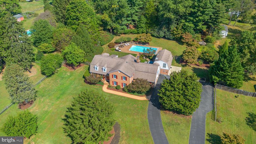 Welcome to 13309 Chestnut Oak Drive—an extraordinary 7-bedroom 4.5 bathroom brick colonial estate nestled on 2 private acres in Darnestown.

Impeccably renovated down to the studs, this residence showcases the pinnacle of quality and attention to detail across its 5,738 square feet of thoughtfully designed living space. The main house features six bedrooms and 3.5 baths, including two en-suite bedrooms—one on each level—plus two dedicated offices. An open-concept gourmet kitchen anchors the home, perfect for entertaining, while the light-filled four-seasons room with elegant Waterford Irish stove and wet bar kitchen forms a sophisticated hub for gatherings.

No detail has been overlooked in the extensive upgrades including new roof (2013), a complete replumb, advanced well water treatment (2024), upgraded 400-amp electrical service, multi-zone HVAC with heat pumps (2014, 2022), hardwired gigabit internet throughout entire property, and regularly serviced septic and well systems.

Outdoor amenities deliver year-round enjoyment for nature lovers with a beautiful low-maintenance in-ground pool (2001) featuring multiple updates including tech-enhanced main pump (2012), sand filter and auto-cover (2016), hot tub (2021), professionally landscaped grounds, a 1,000-gallon propane system, and electrical to the gazebo and custom Amish-built shed (32'x14'). 

The charming two-level, 992-square-foot guest house provides privacy and flexibility for visitors or multi-generational living, complete with its own kitchen and Waterford Irish Stove.  

This turnkey estate reflects over two decades of meticulous investment, blending luxury, functionality, and serene natural beauty. For discerning buyers seeking the very finest, this is the signature property in the area—an opportunity not to be missed. *Do not miss 3D Walkthrough Videos for both Main and Guest House and floor plans!*